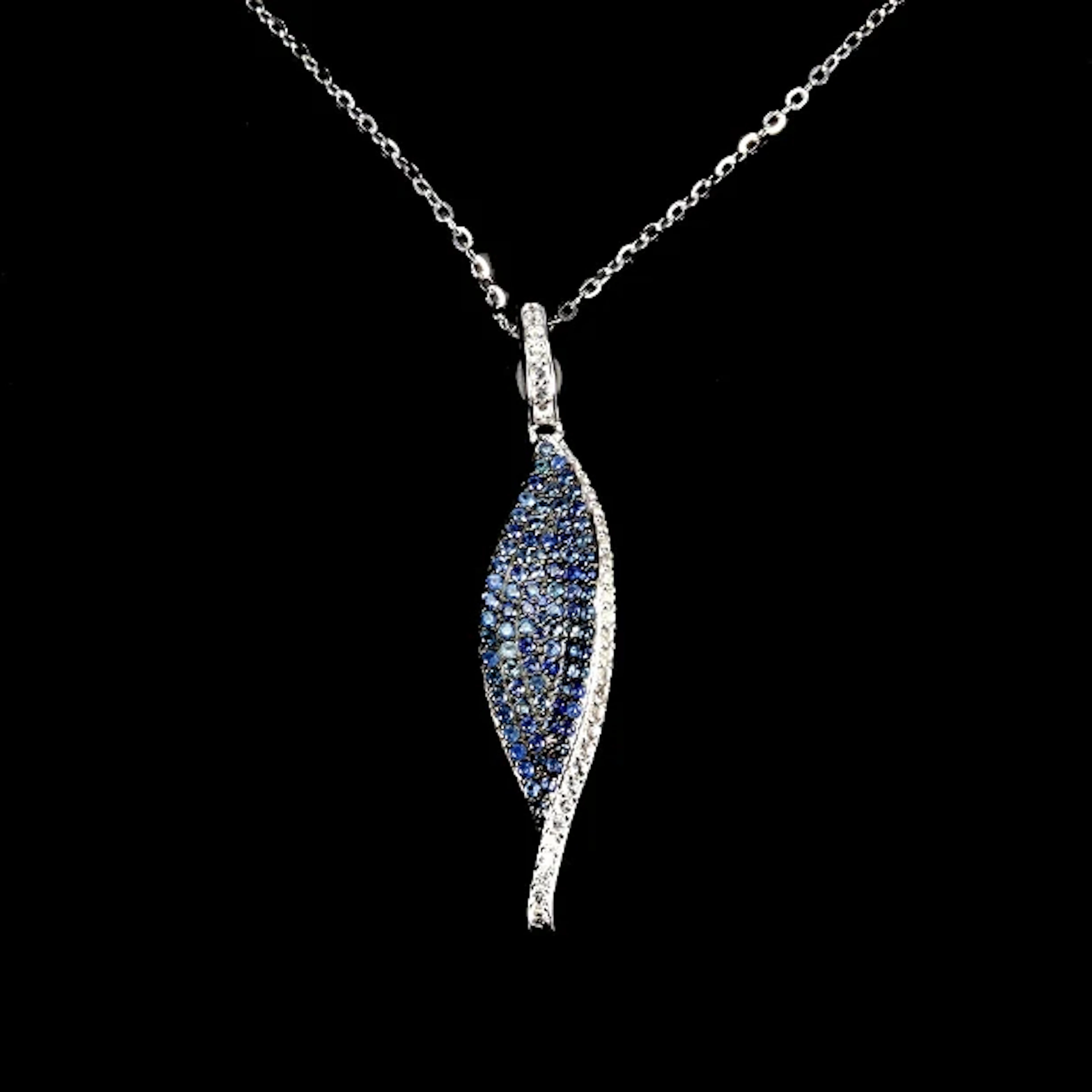 Pendant. Rhodium-plated sterling silver, sapphire and topaz.