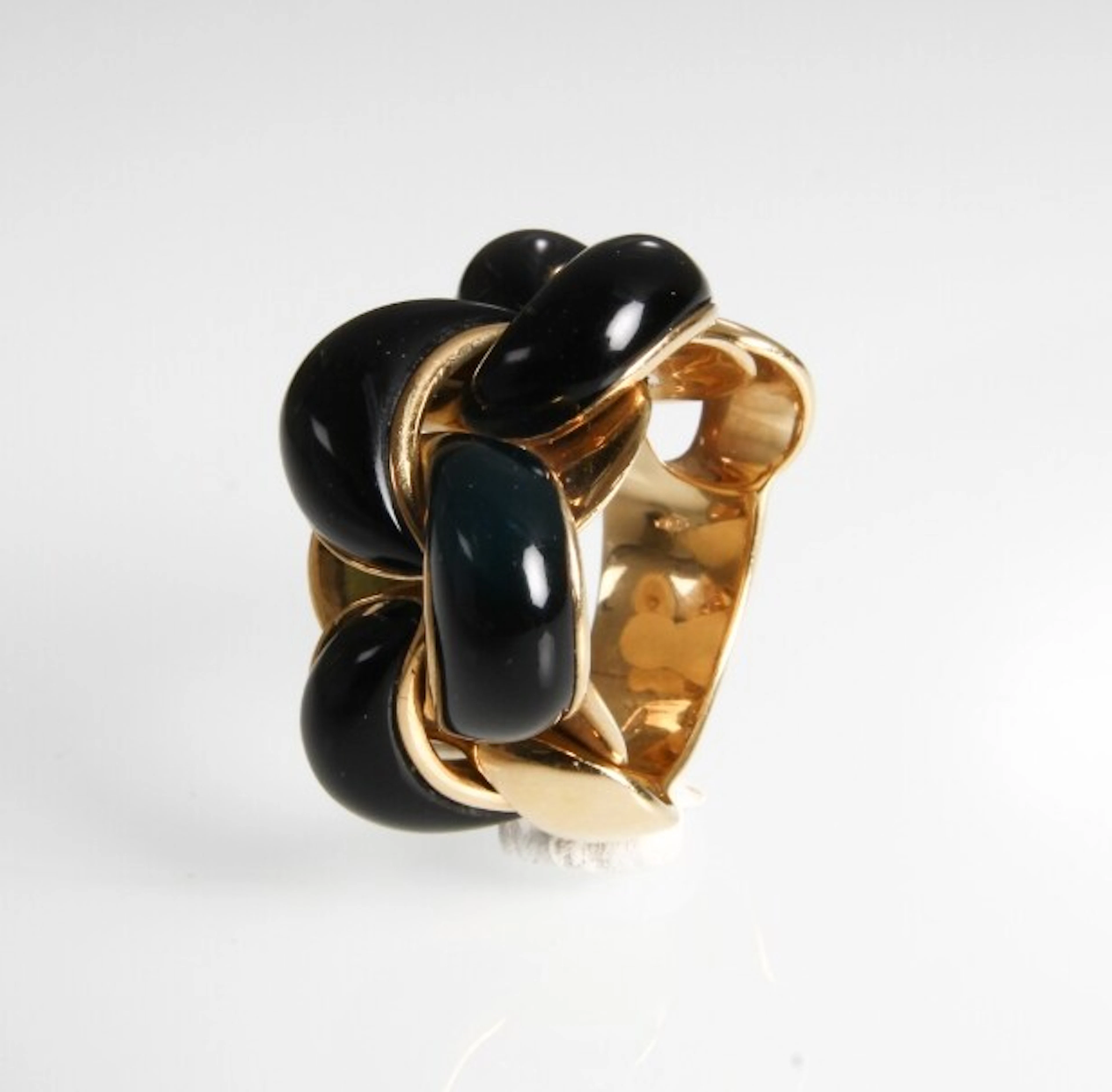 Italian braided ring made of 18 kt. gold adorned with black enamel.