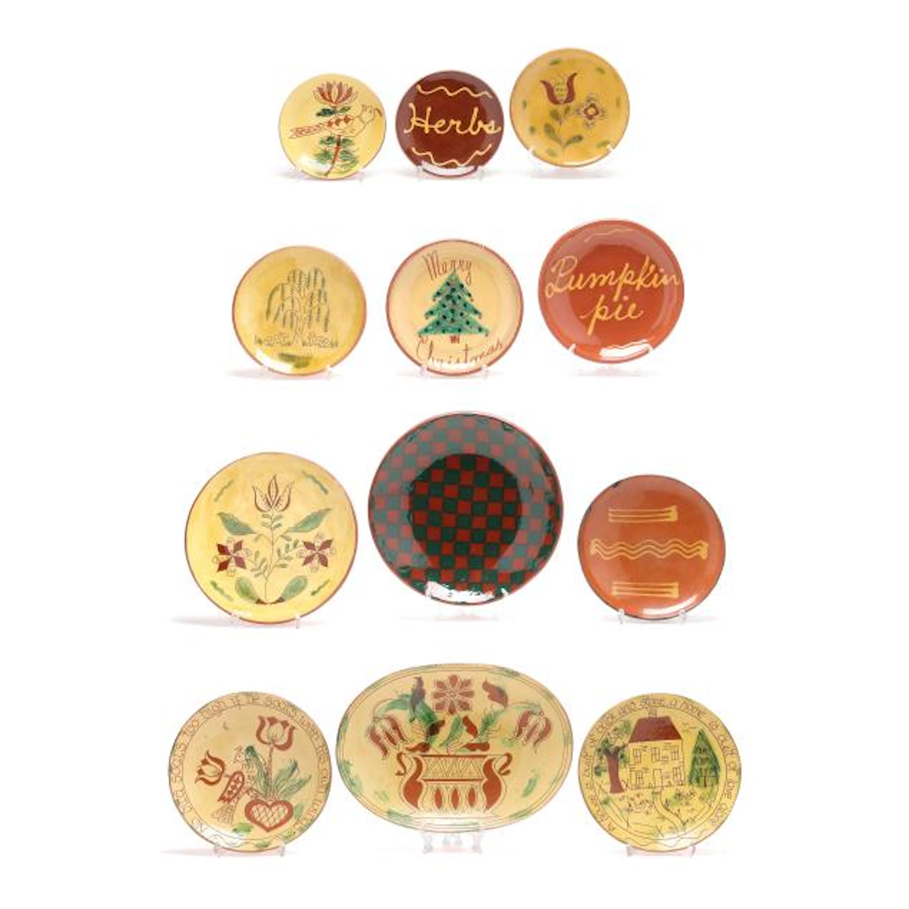 Twelve Assorted Pennsylvania Slip Decorated Redware Plates
