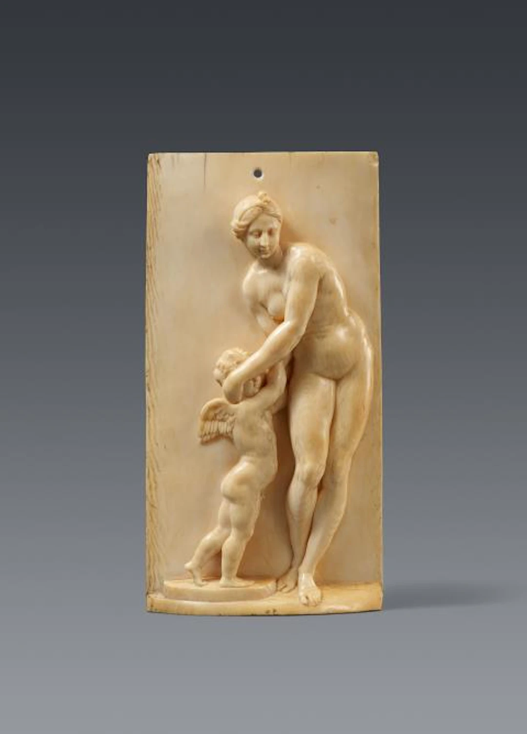 A carved ivory relief with Venus and Cupid