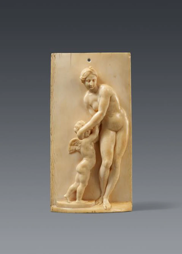 A carved ivory relief with Venus and Cupid