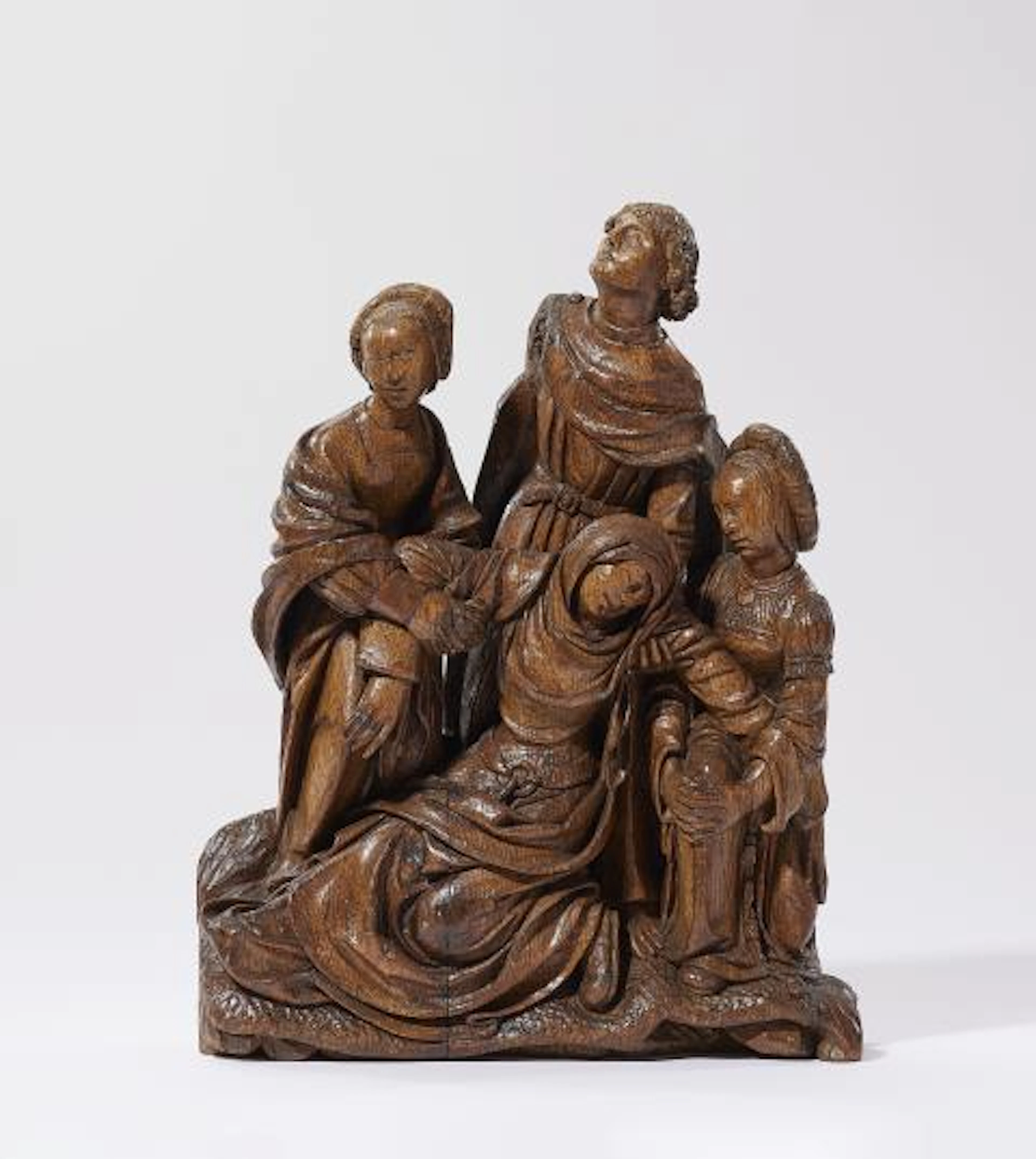 A carved oak group with the swooning Virgin Mary