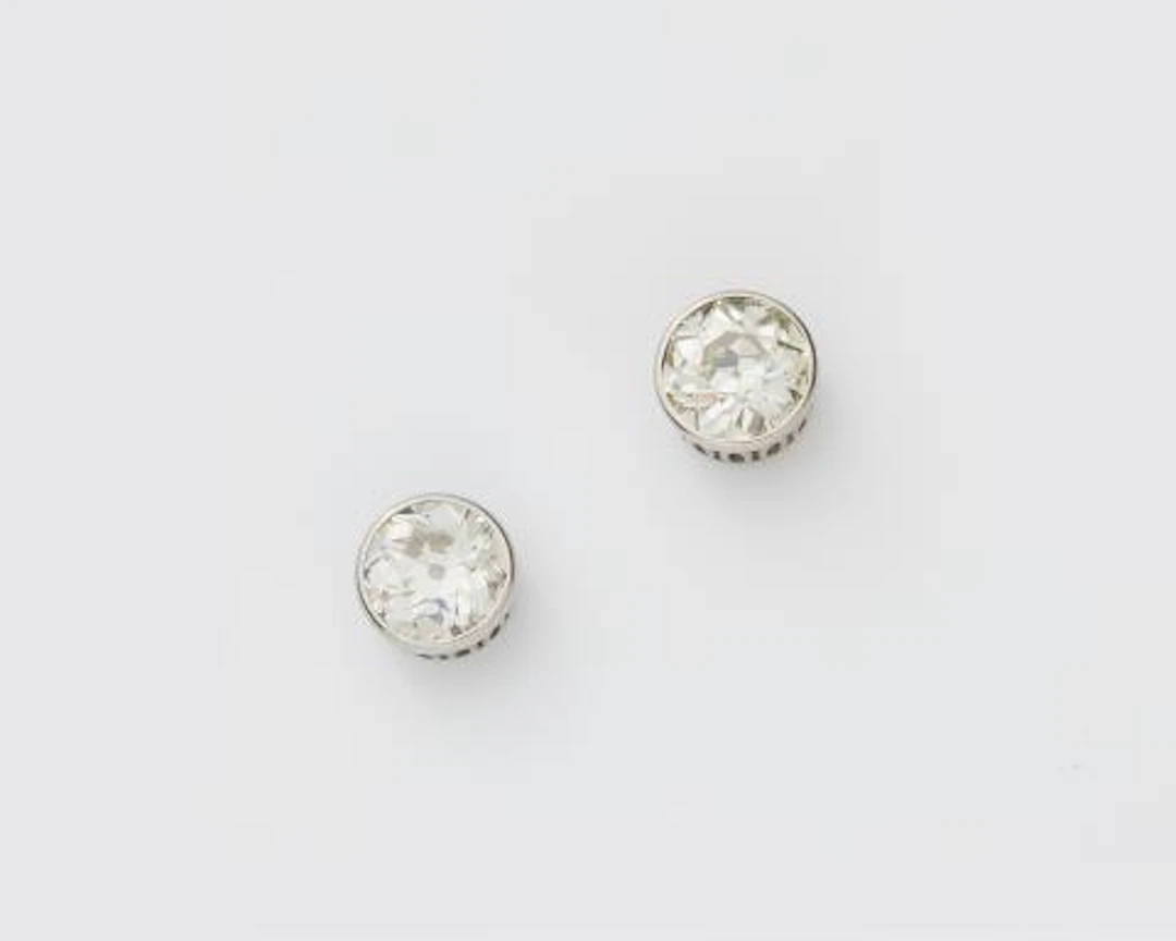 A pair of 18k white gold diamond solitaire ear studs.