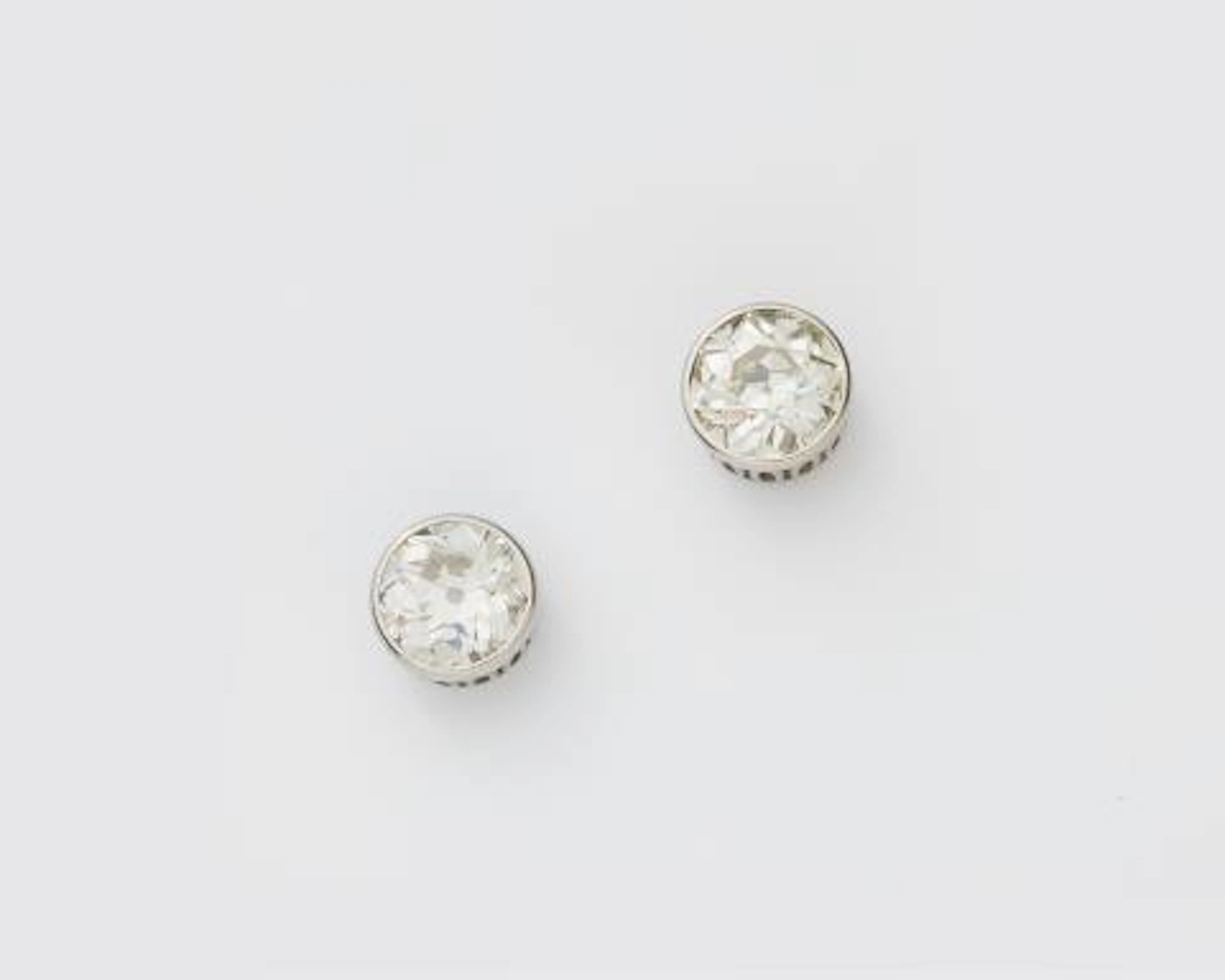 A pair of 18k white gold diamond solitaire ear studs.