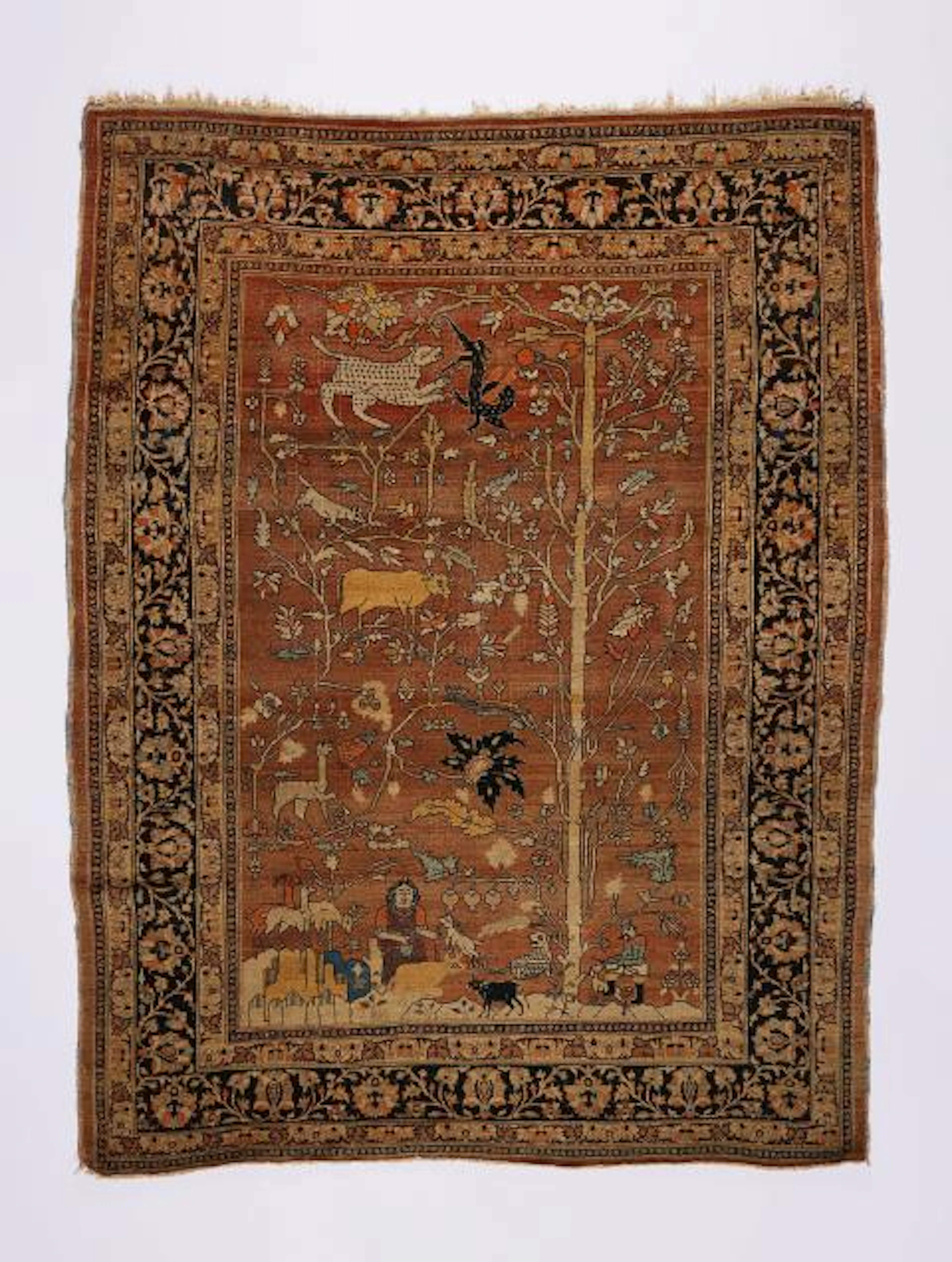 A Tabriz carpet with a hunting scene and tree of life motif