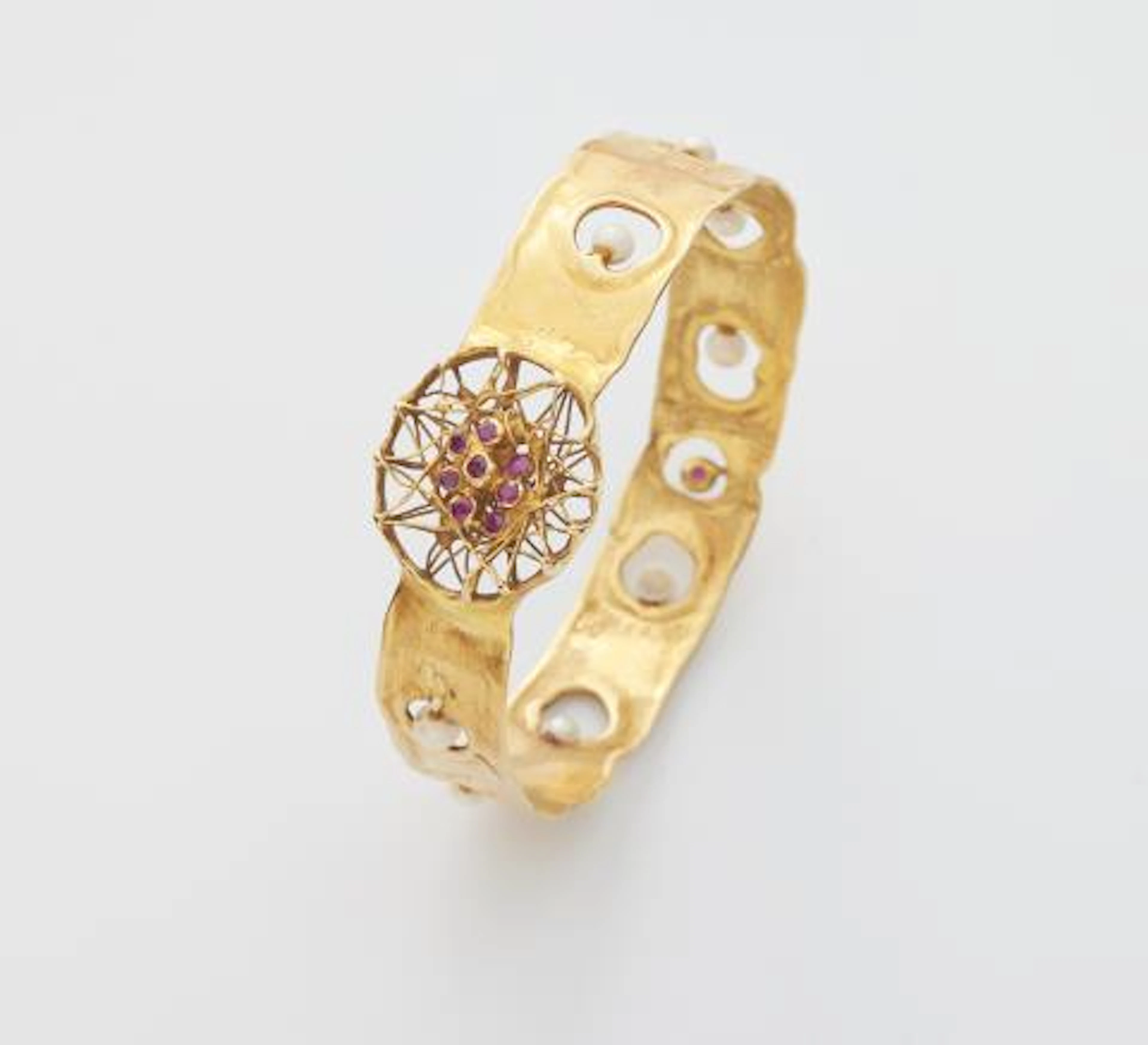 A German hand-forged 18k gold pearl and ruby bangle.