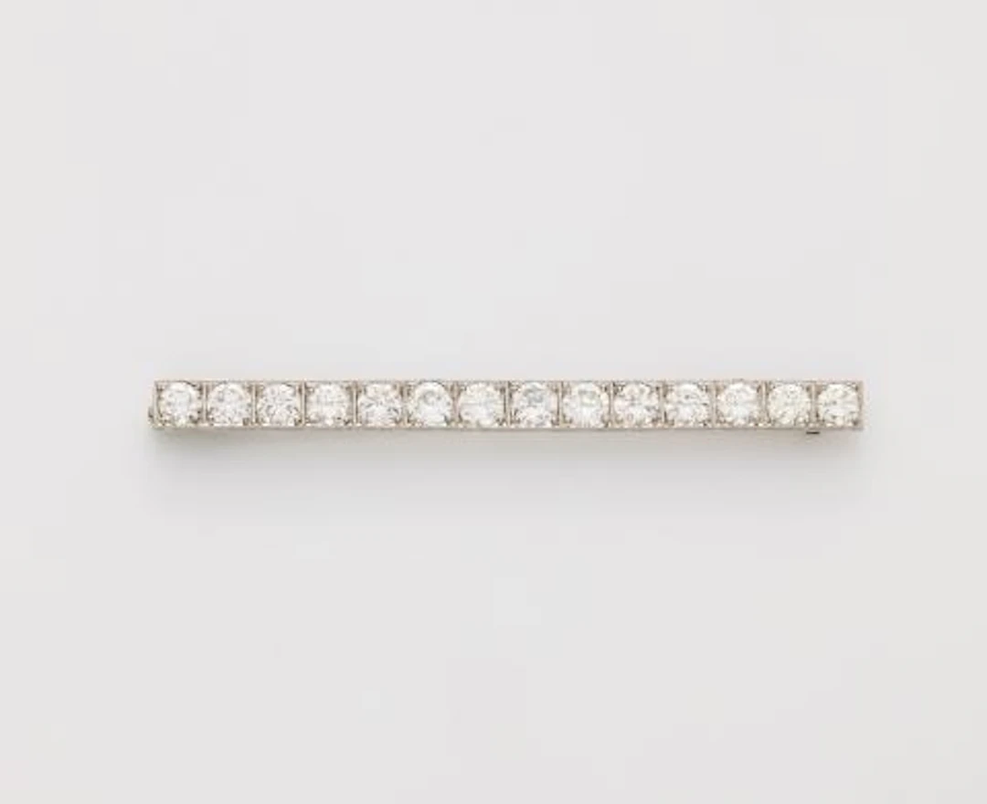 A platinum and brilliant-cut diamond Art Déco bar brooch with replaced