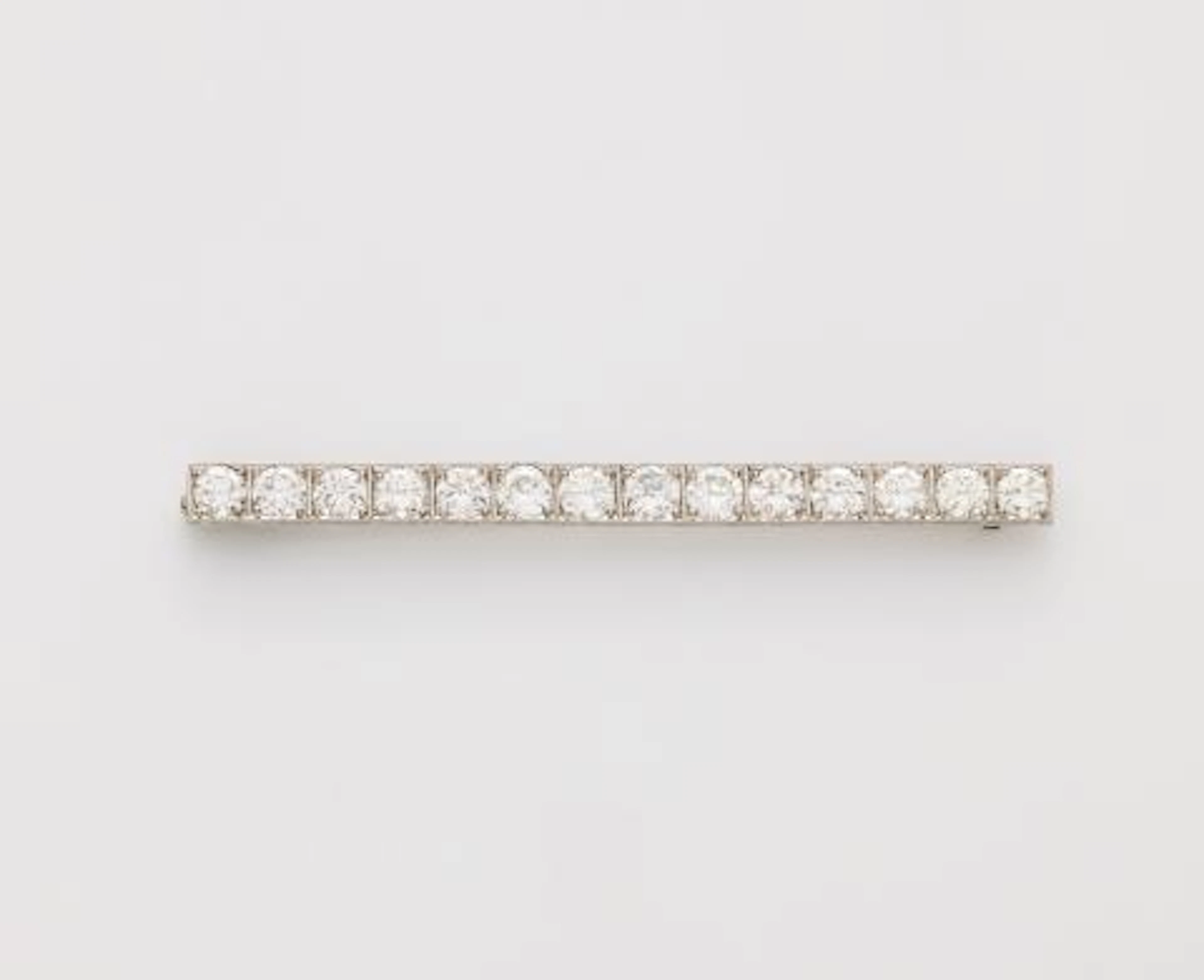 A platinum and brilliant-cut diamond Art Déco bar brooch with replaced