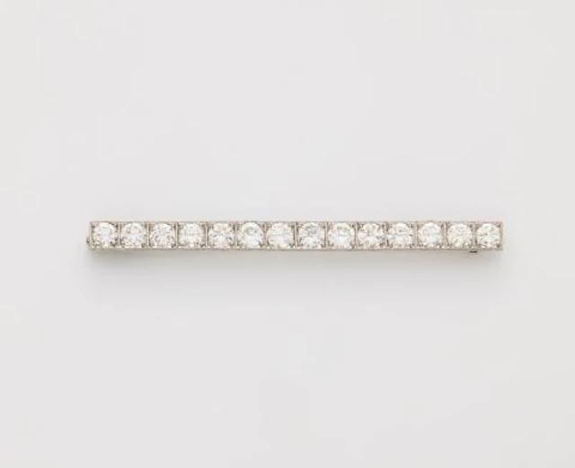 A platinum and brilliant-cut diamond Art Déco bar brooch with replaced