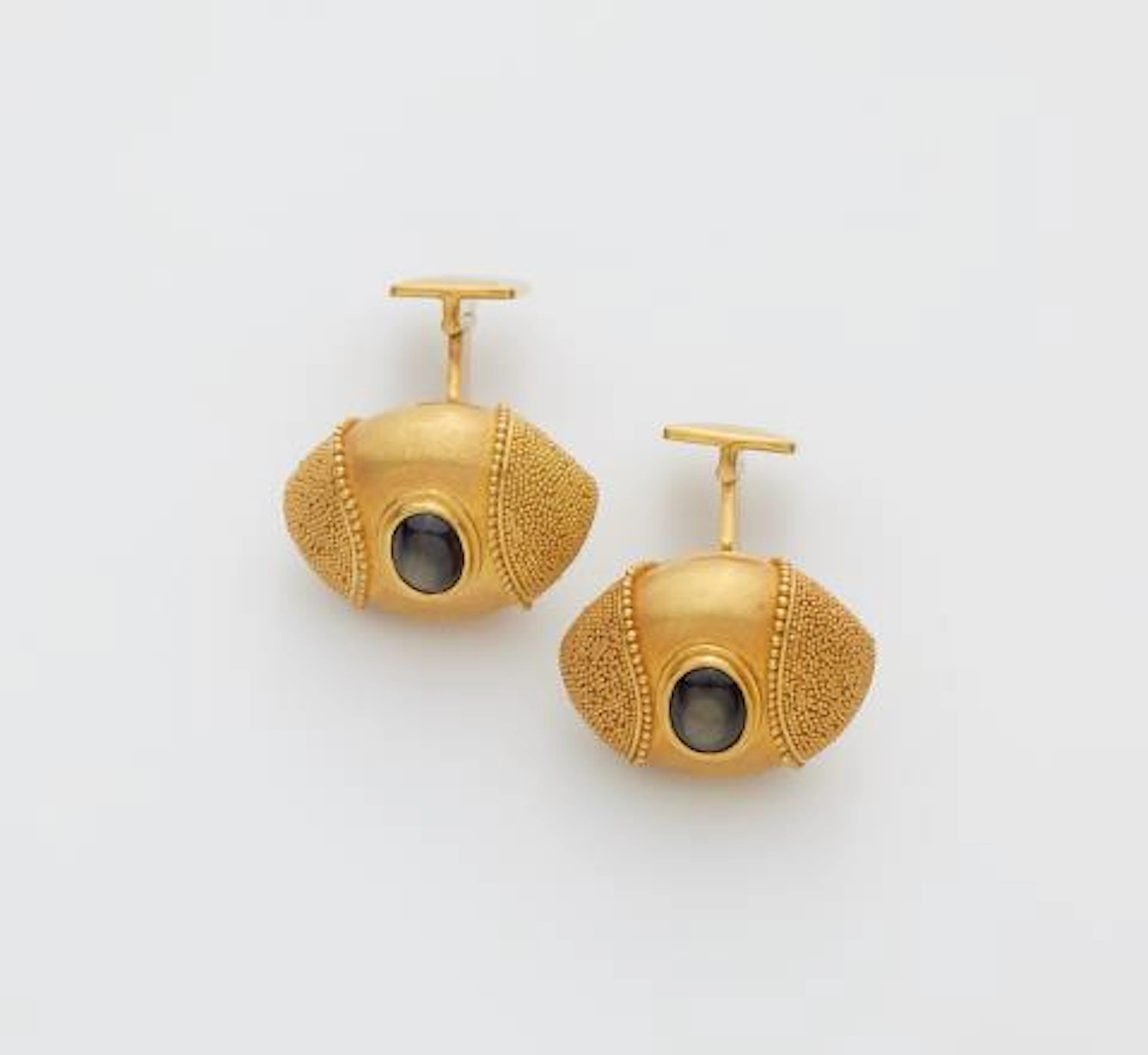 A pair of German 18k gold granulation and black star sapphire cufflinks.