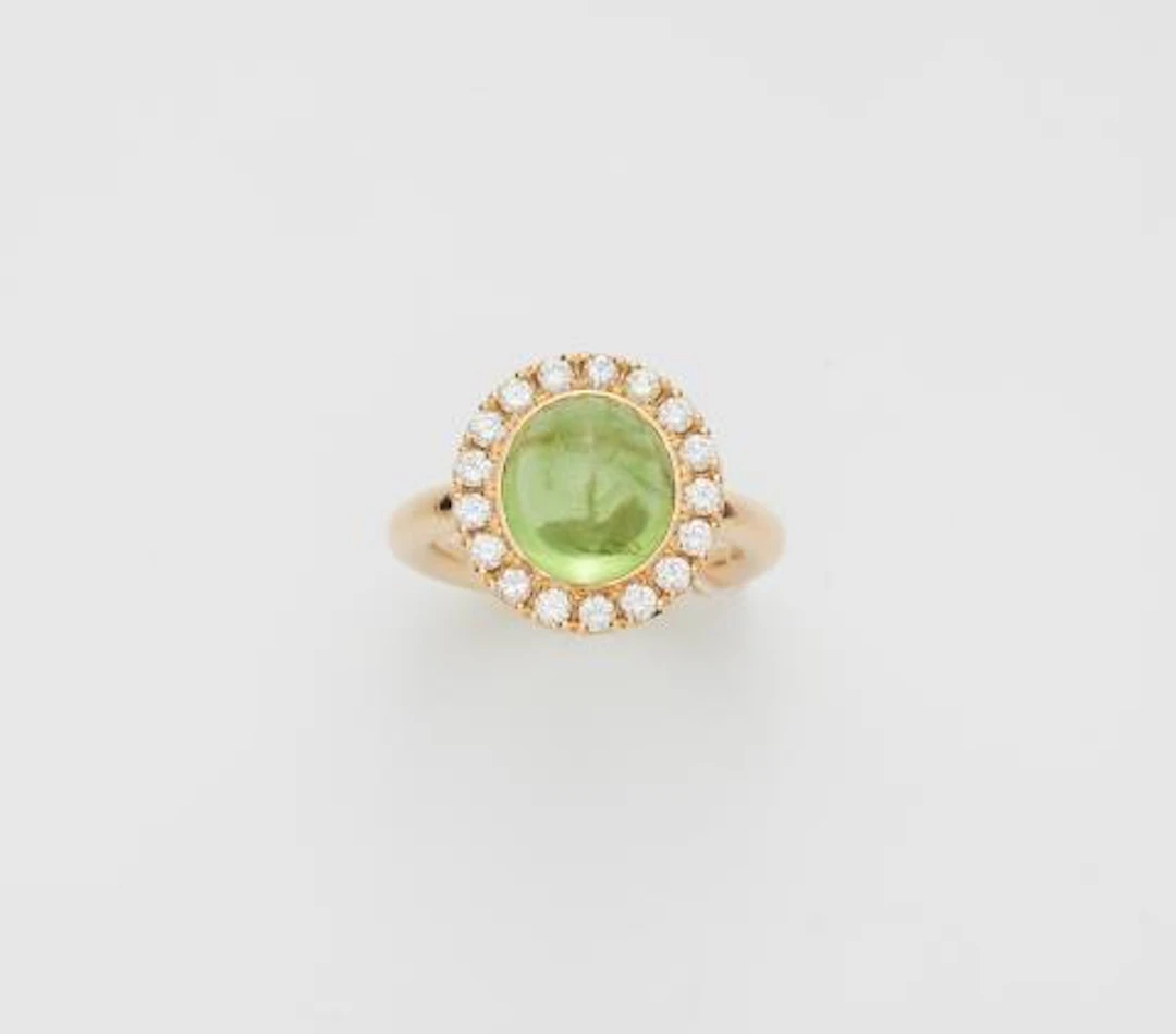 An 18k yellow gold diamond and peridot cabochon cluster ring.