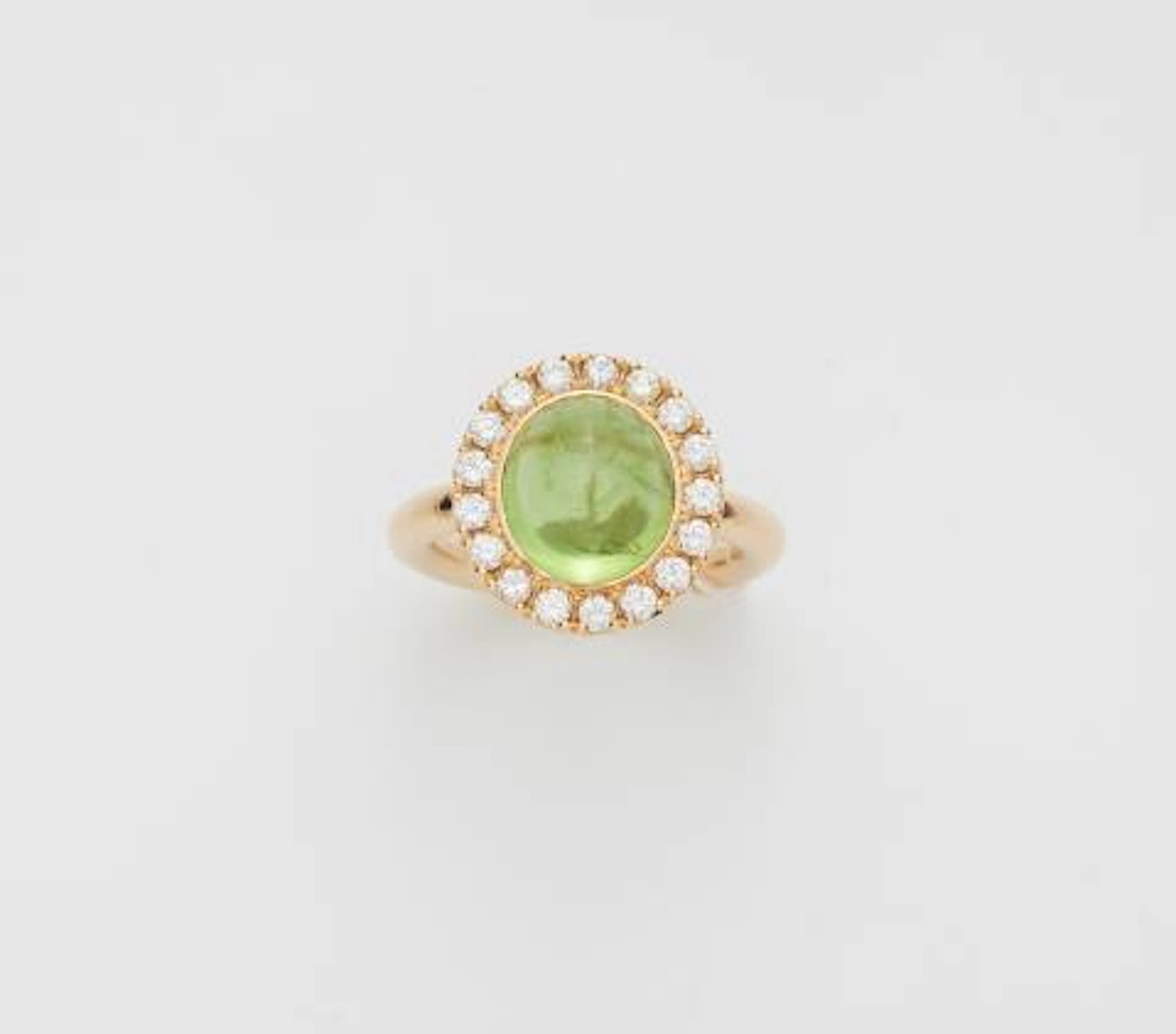 An 18k yellow gold diamond and peridot cabochon cluster ring.