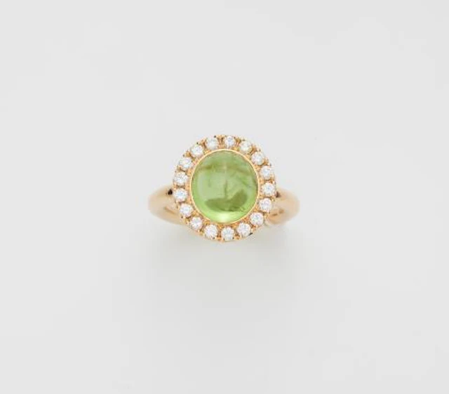 An 18k yellow gold diamond and peridot cabochon cluster ring.