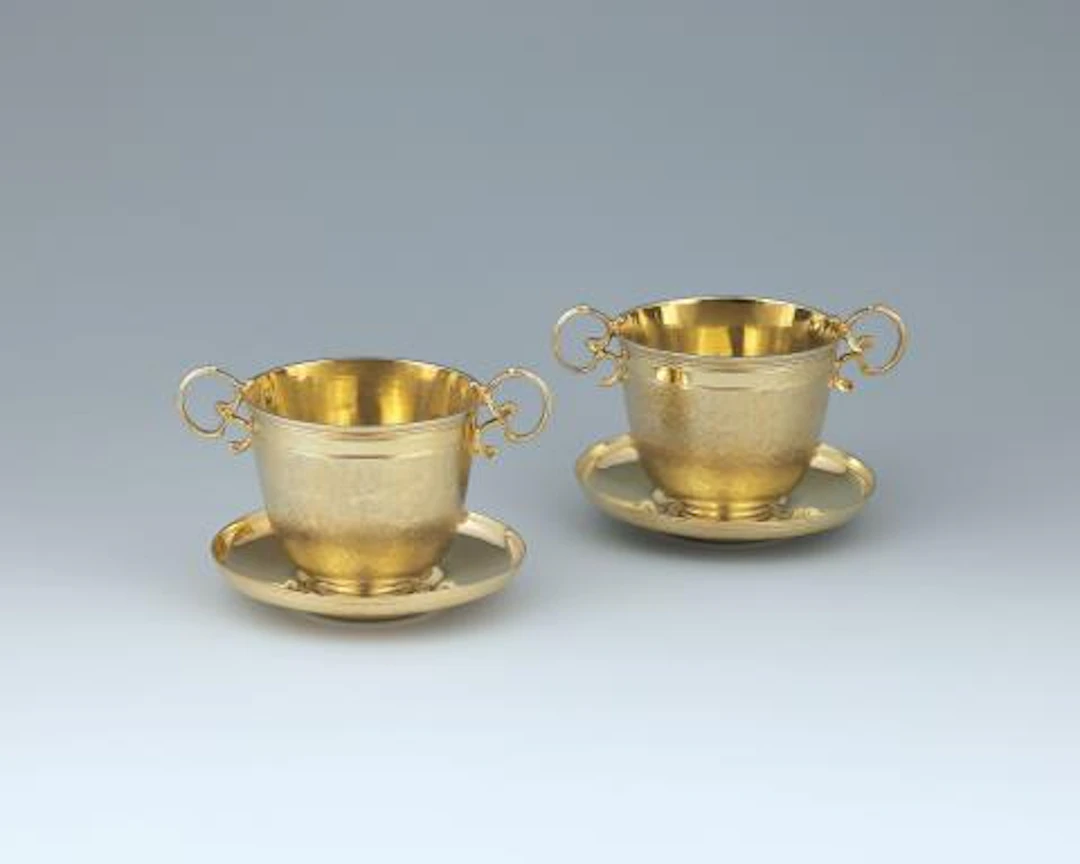 A pair of Augsburg silver gilt beakers with saucers