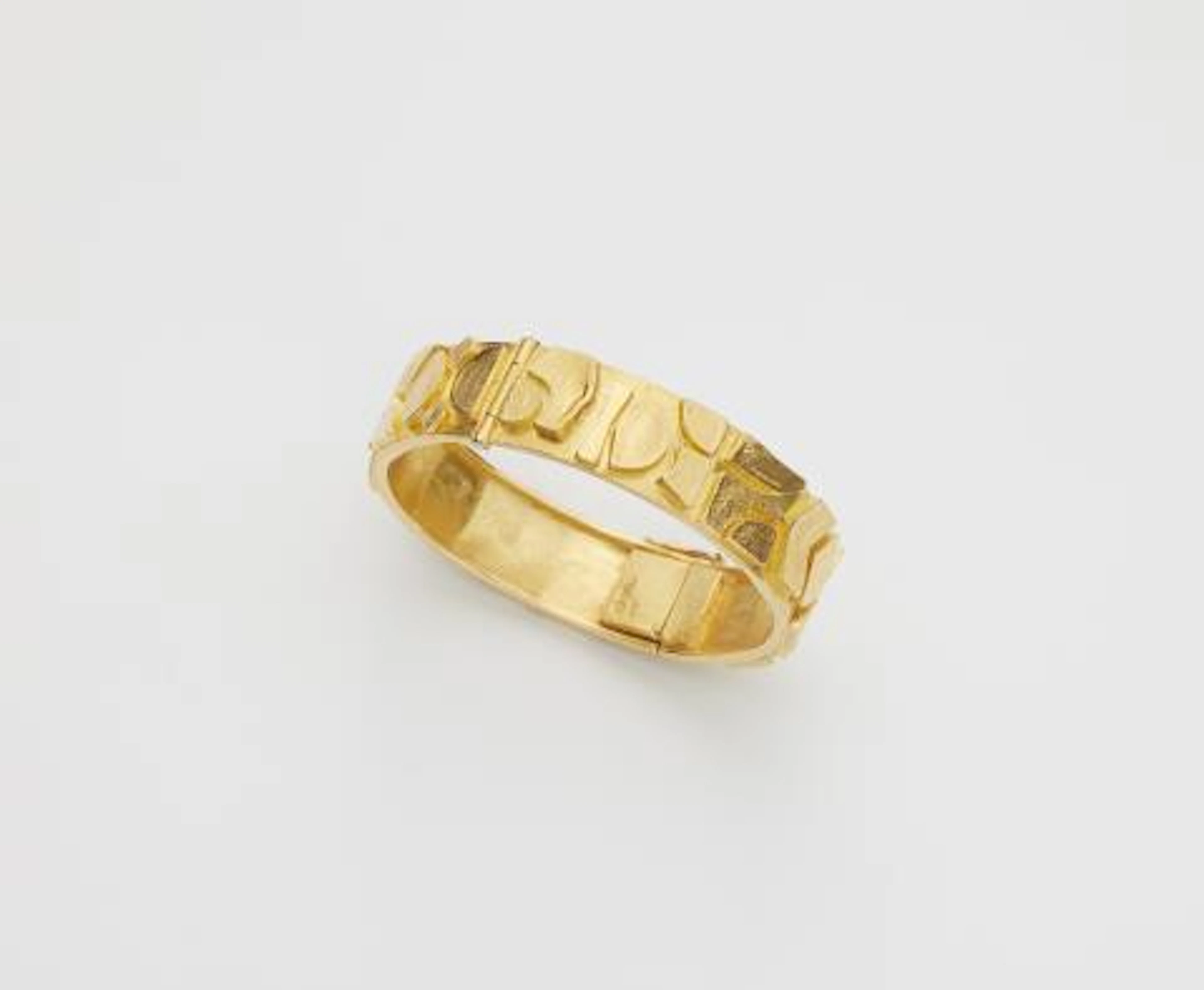 A German hand-forged gilded 18k gold geometrical bangle.