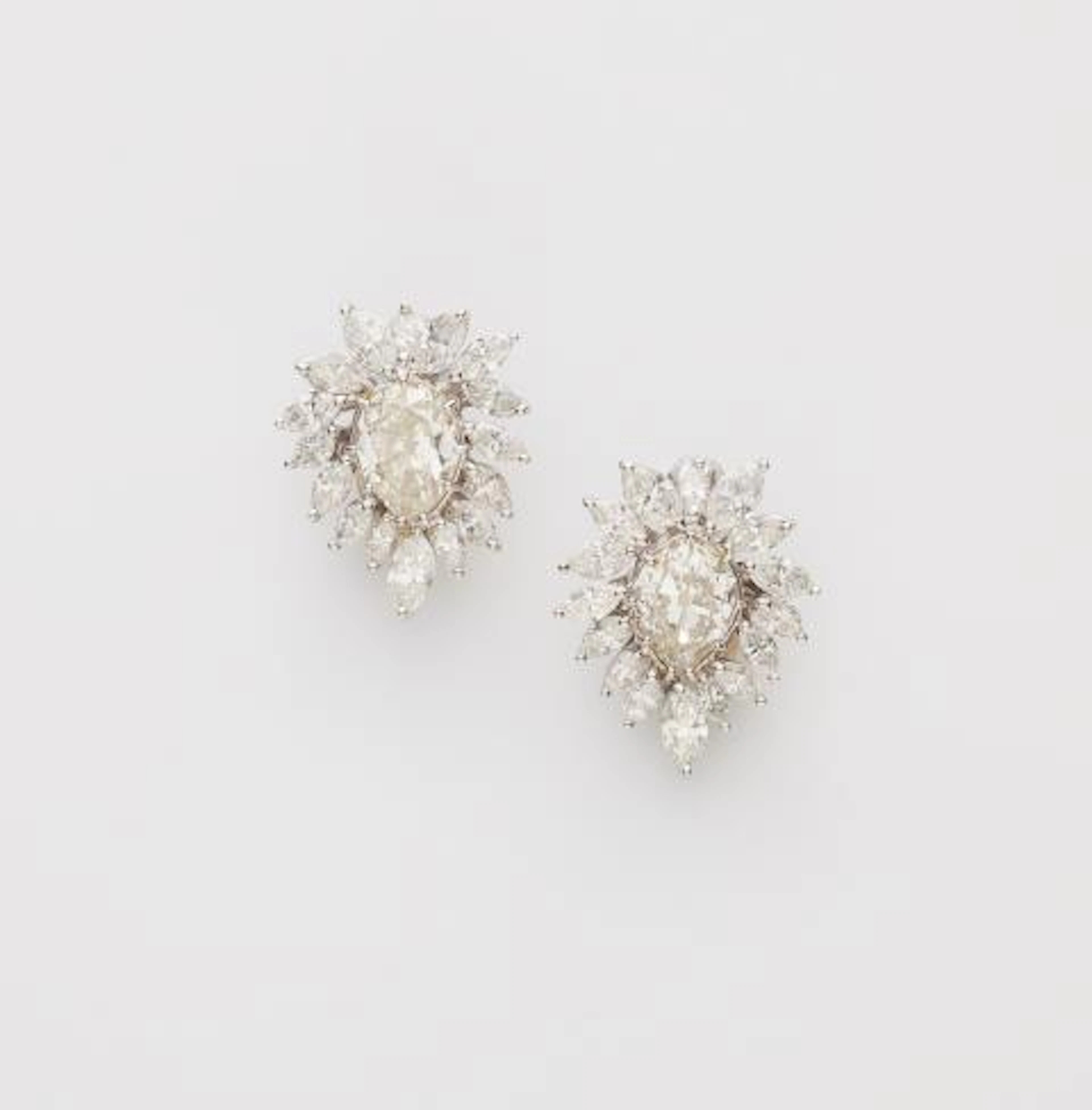 A pair of 18k white gold and diamond cocktail clip earrings.