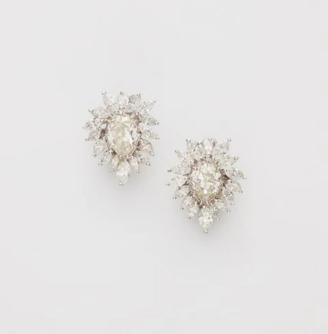 A pair of 18k white gold and diamond cocktail clip earrings.