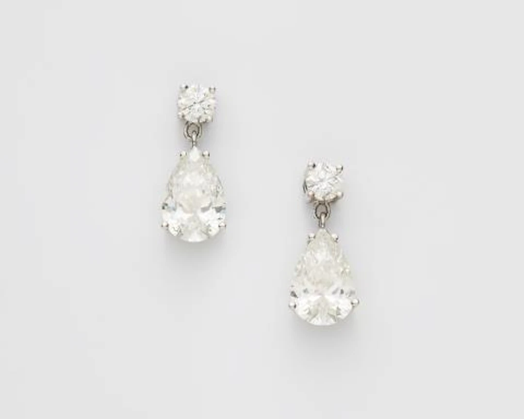 A pair of 18k white gold and diamond earrings with a fine matching