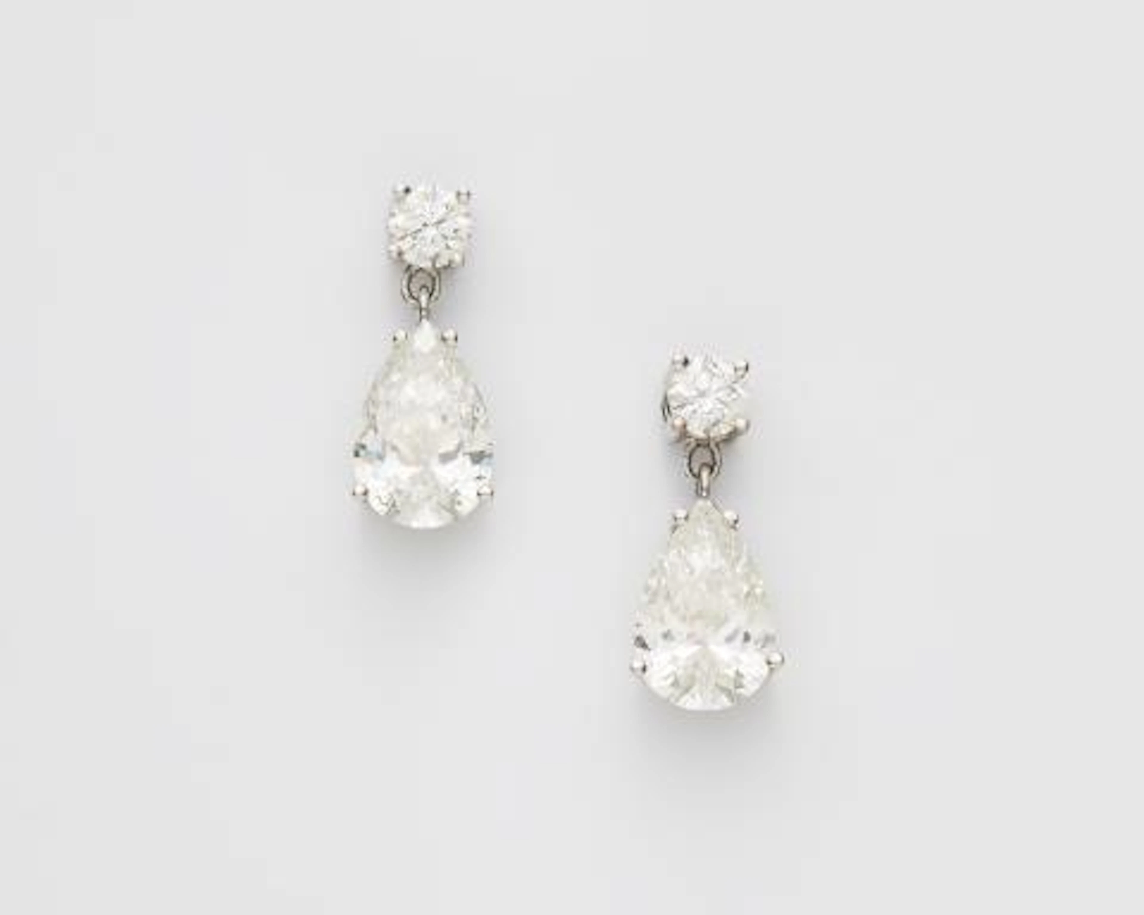 A pair of 18k white gold and diamond earrings with a fine matching