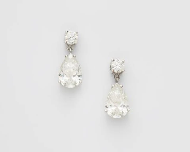 A pair of 18k white gold and diamond earrings with a fine matching