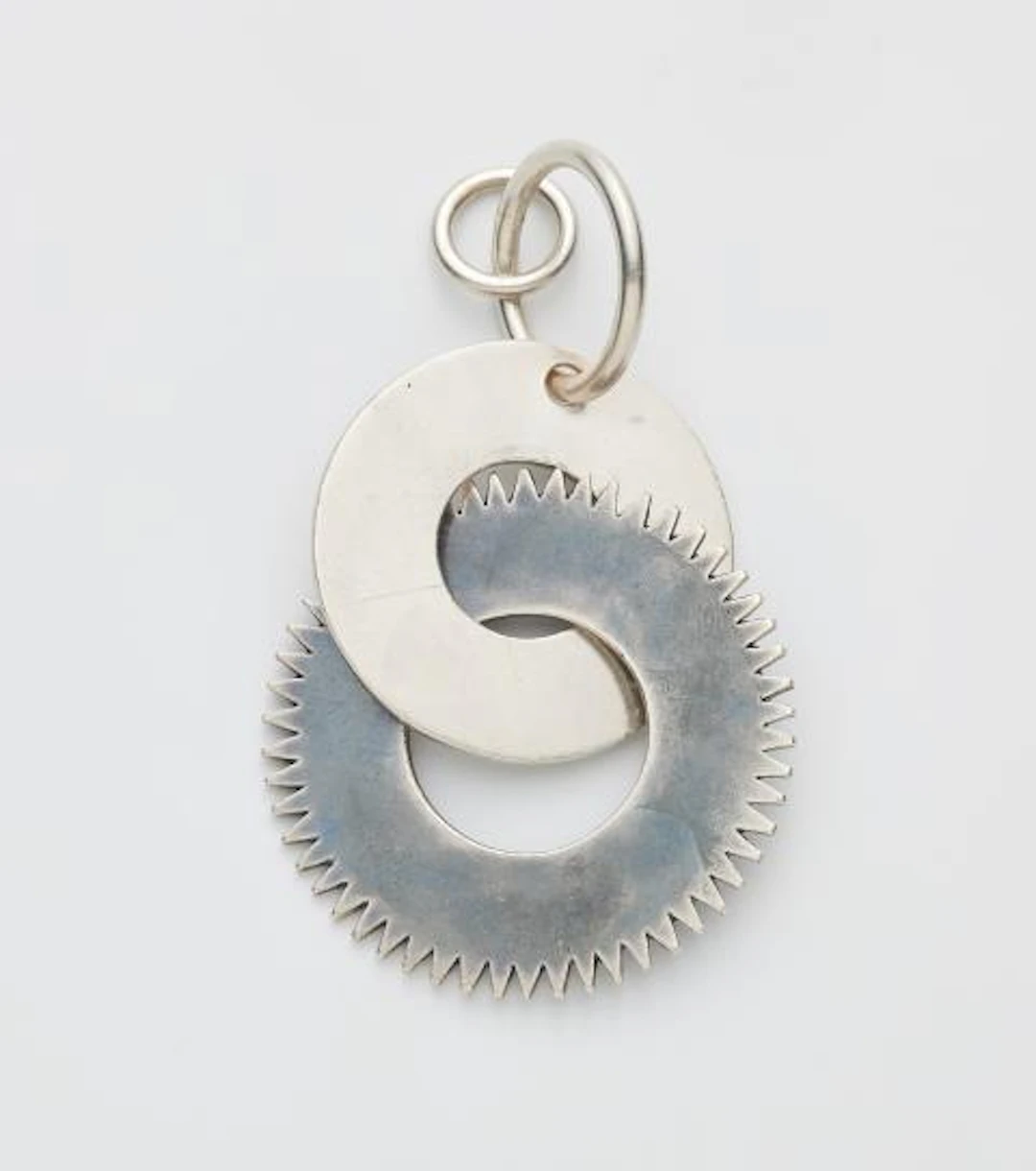 A French partially oxydised silver Art Déco pendant with a cog motif.