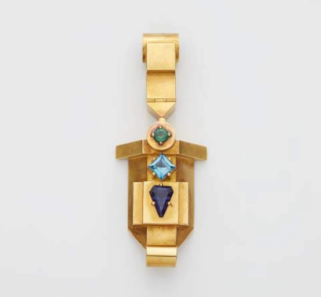 A German chased 18k gold and coloured gemstone pectoral pendant.