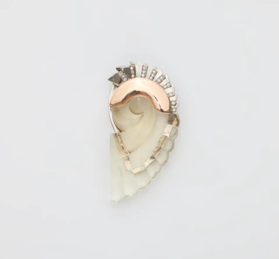 A 14k bicolour gold diamond and carved quartz Retro Style dress clip.