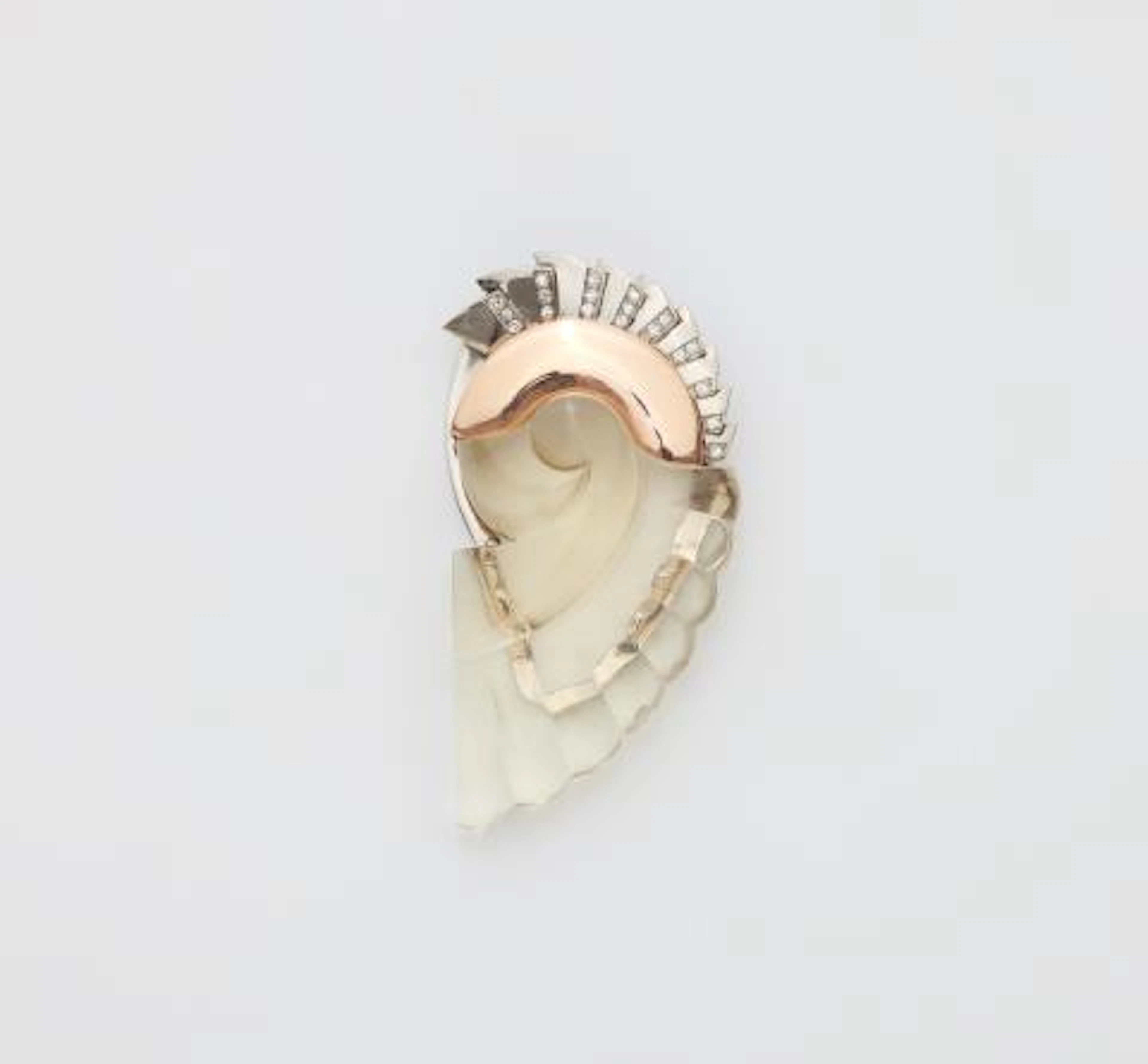 A 14k bicolour gold diamond and carved quartz Retro Style dress clip.