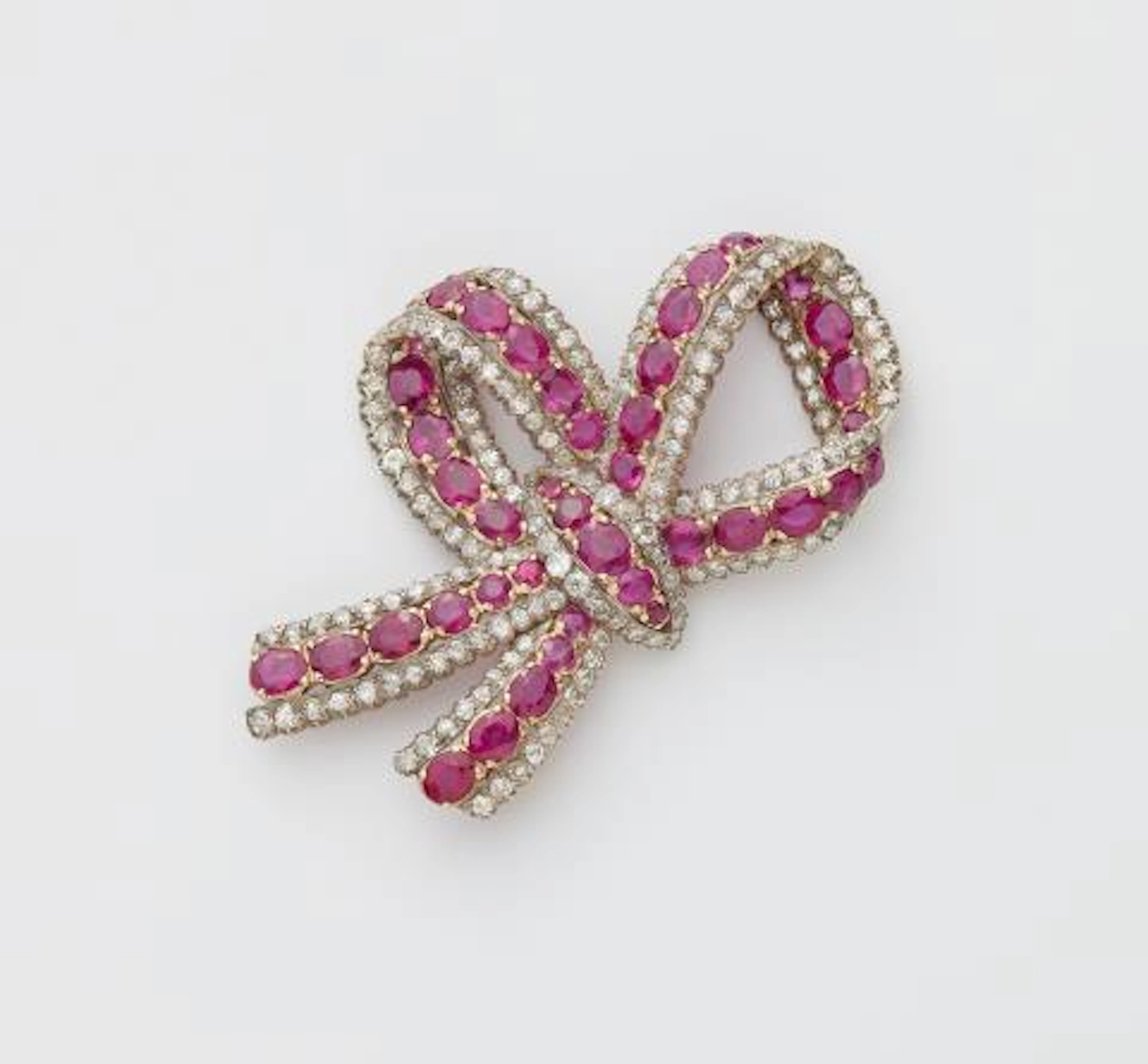 A 14k gold diamond and ruby Belle Epoque bow brooch.