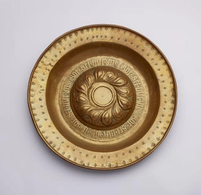 A brass 'Beckenschlägerschüssel' with a raised tracery rosette