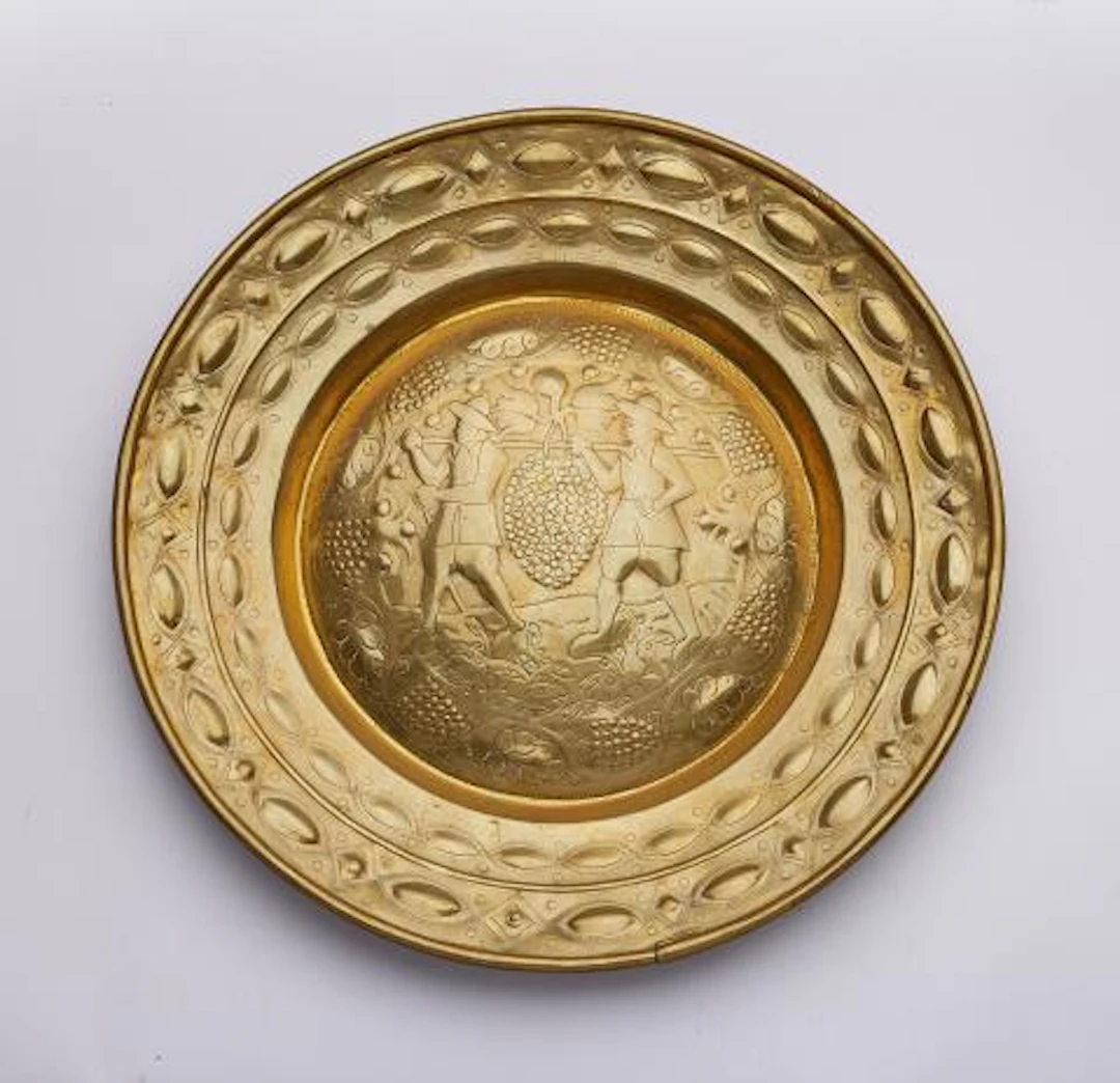 A brass alms bowl with Joshua and Caleb