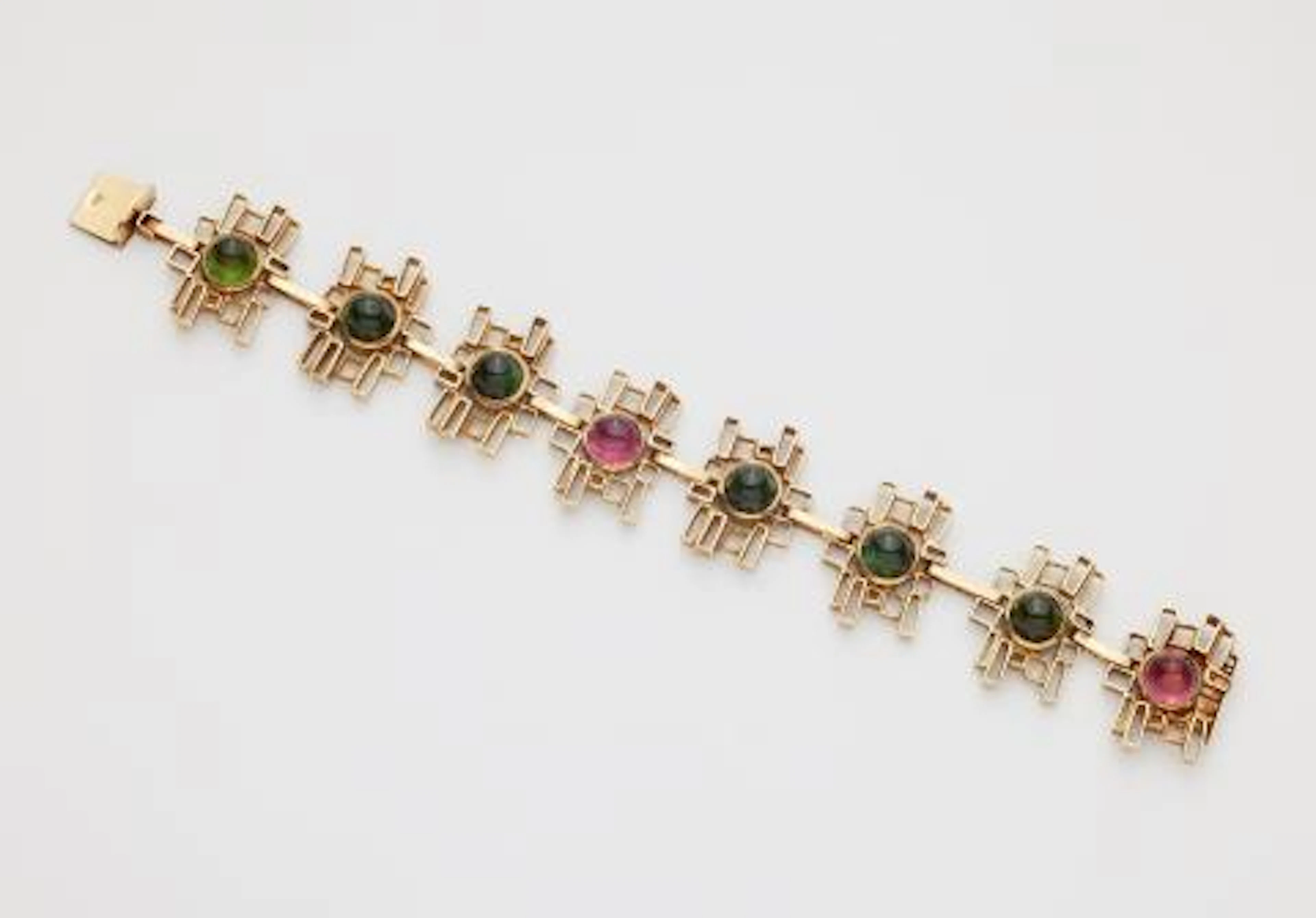 A 14k gold and sugarloaf-cut green and pink tourmaline bracelet.