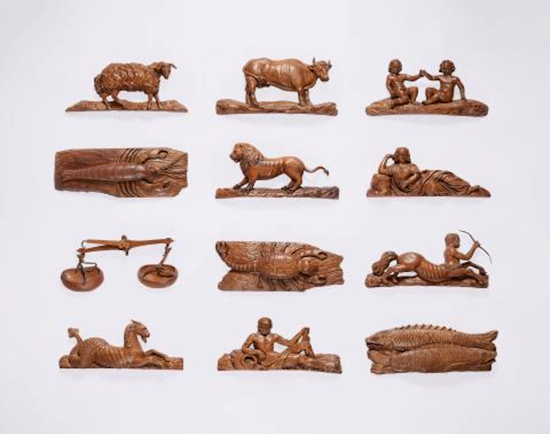 Twelve carved oak zodiac reliefs