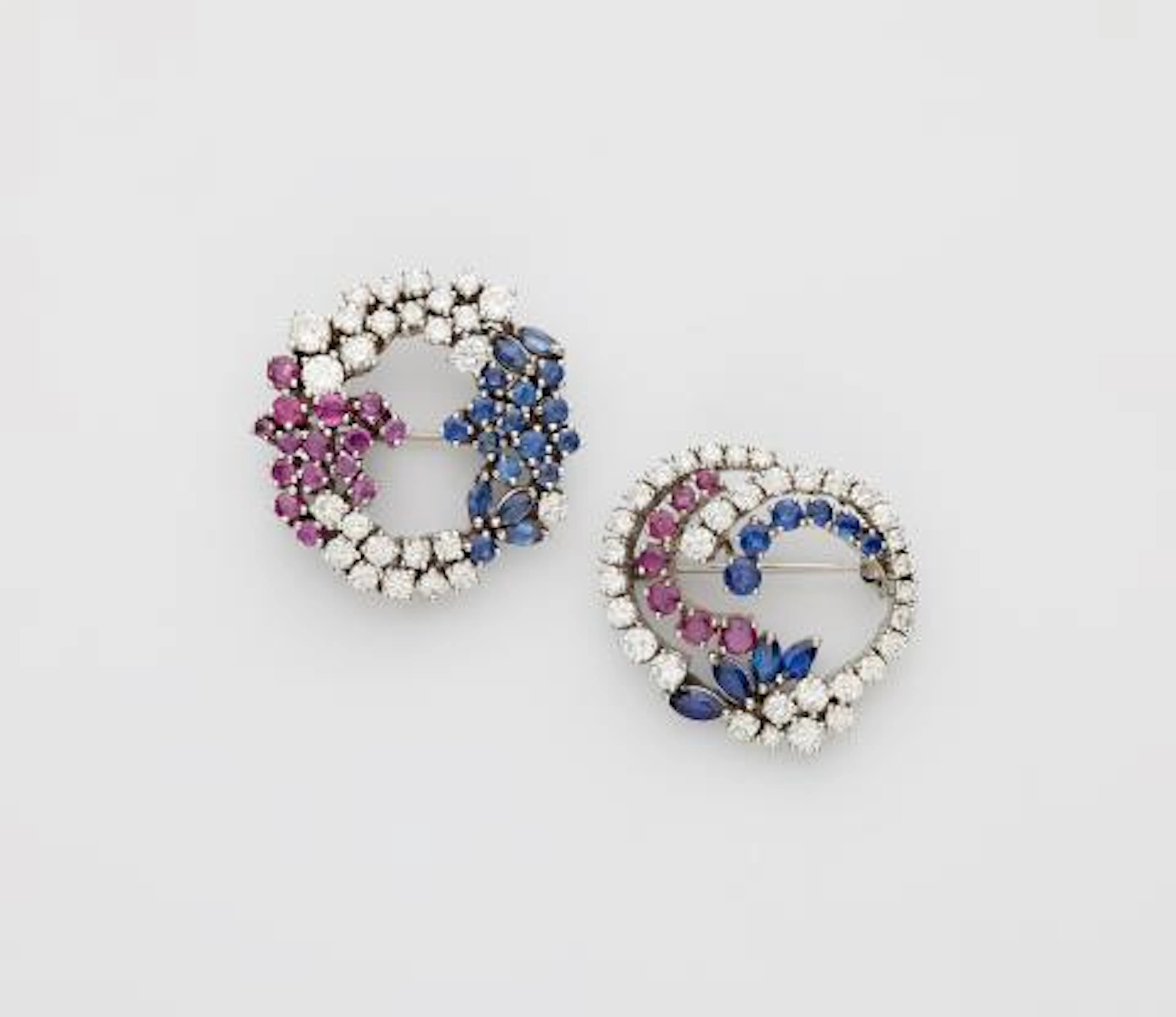 Two 14k white gold, ruby, sapphire and diamond wreath brooches.
