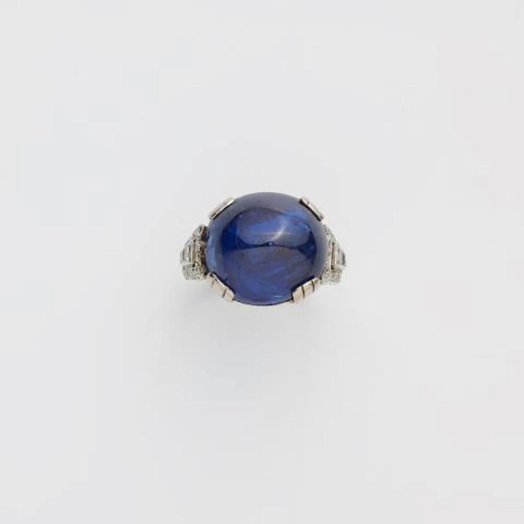A rhodium plated 18k gold diamond and sugarloaf-cut natural Burmese