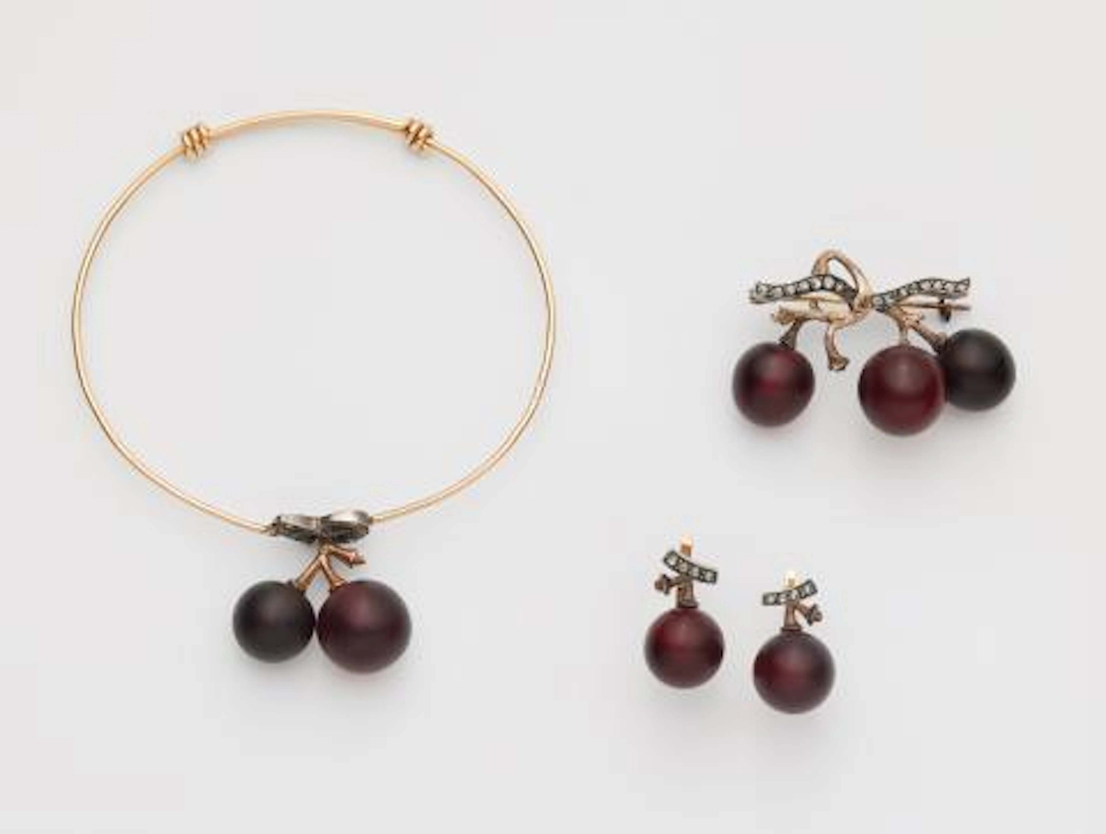 A French 18k gold silver and frosted red glass suite with grape motifs