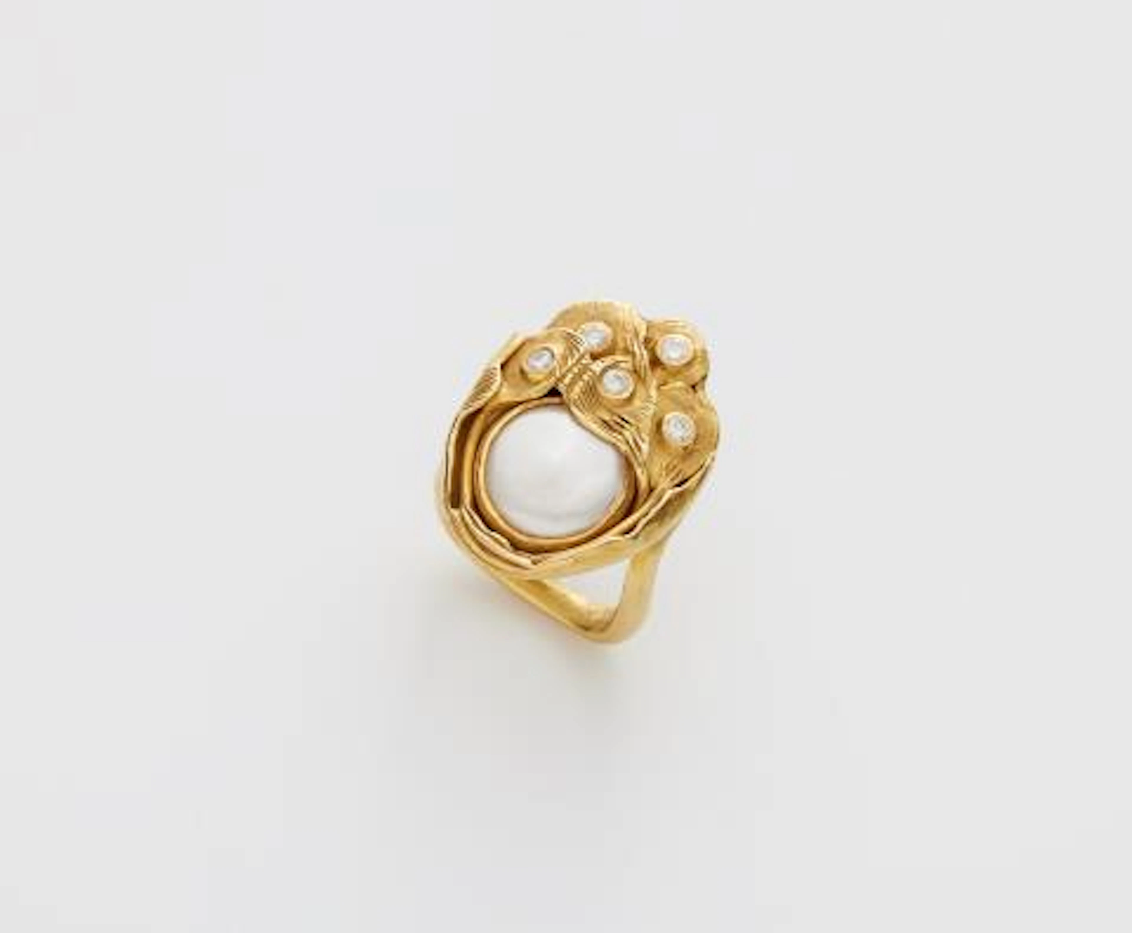 A German hand-forged 18k gold mother of pearl and diamond ring.
