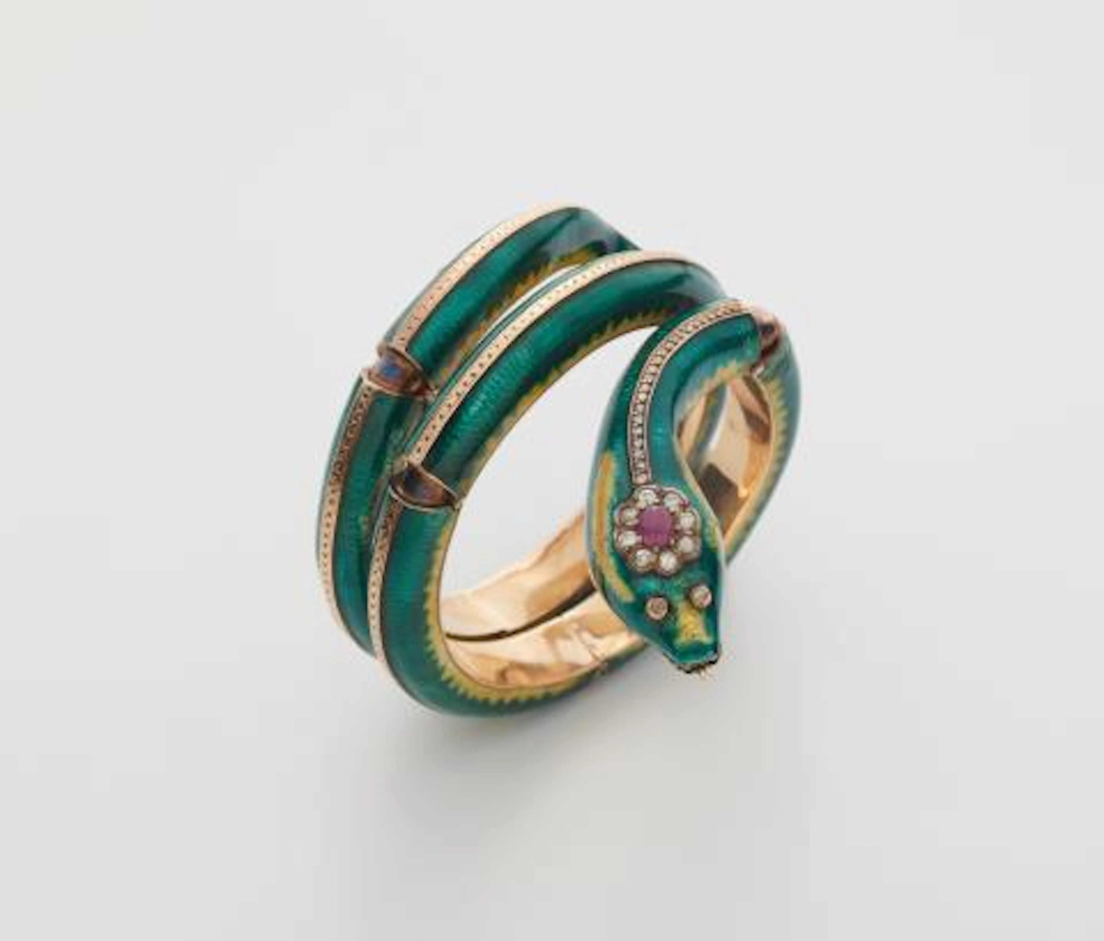 A 15k red gold translucent guilloché enamel diamond and ruby snake bangle.