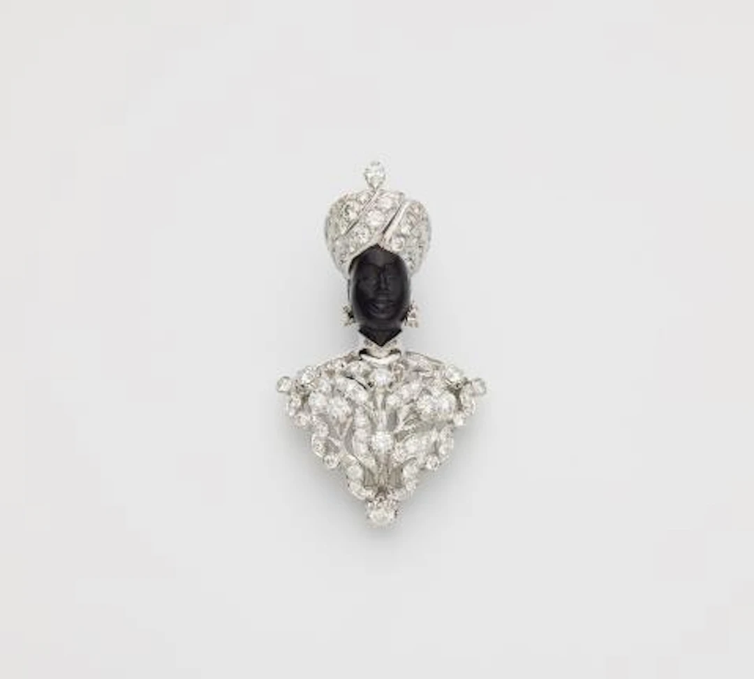 An Italian 18k white gold black amber and diamond Moretto clip brooch.