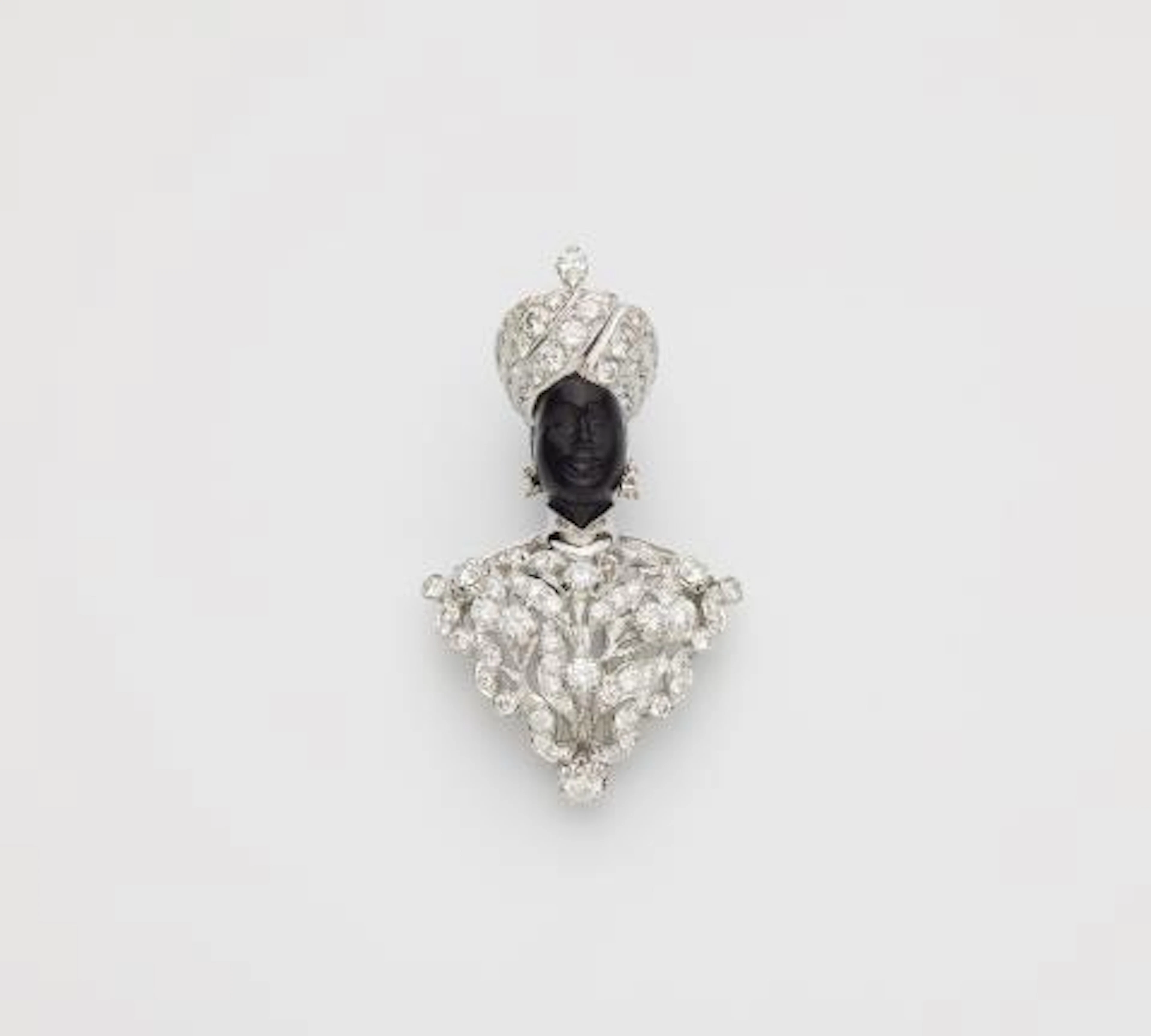 An Italian 18k white gold black amber and diamond Moretto clip brooch.