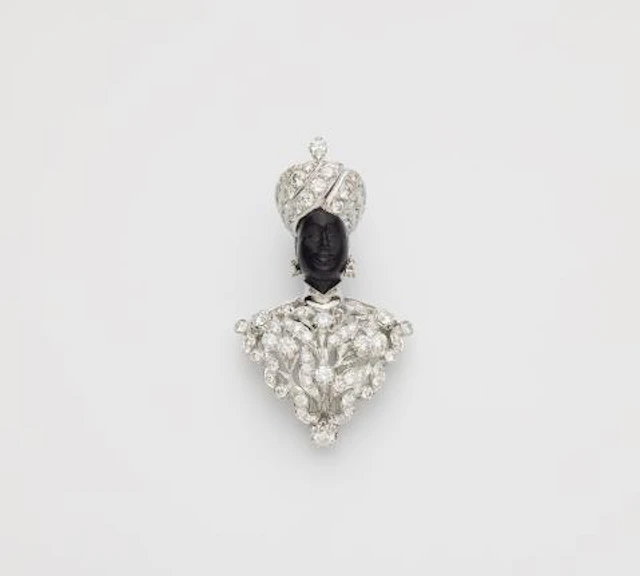 An Italian 18k white gold black amber and diamond Moretto clip brooch.