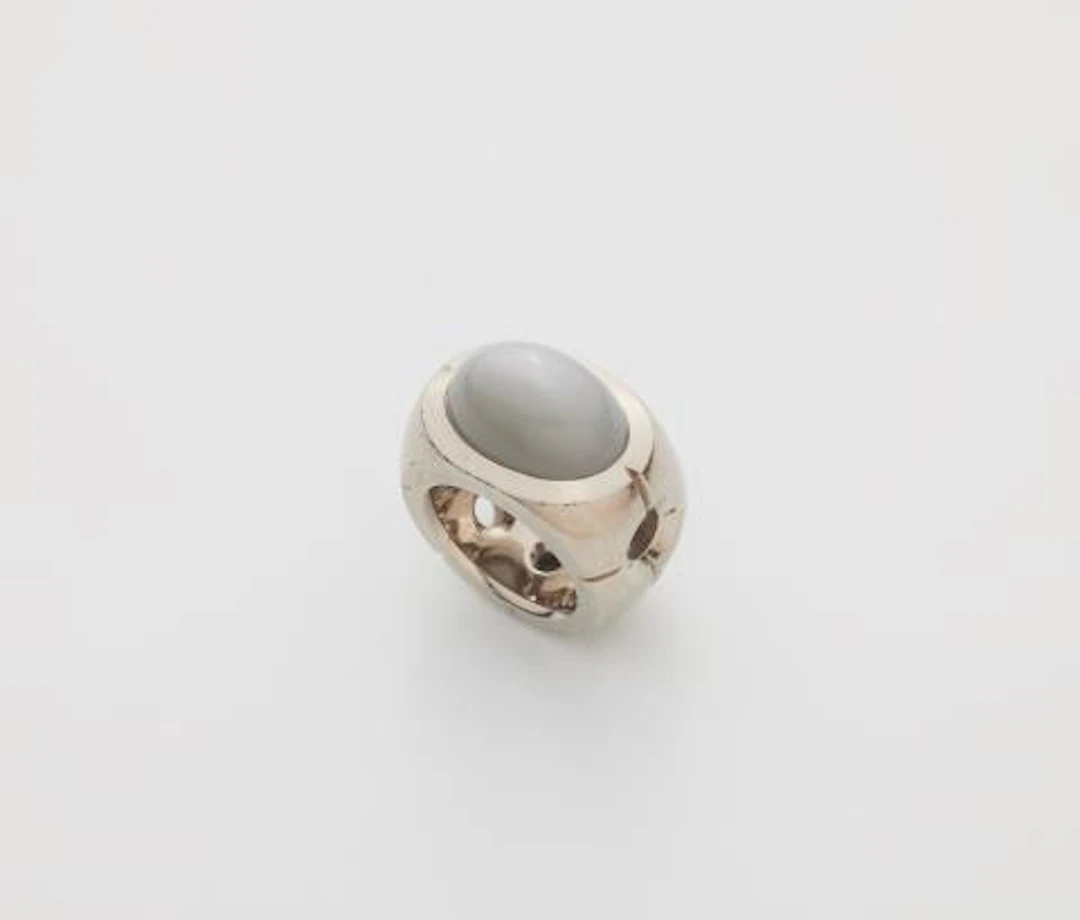 A solid 18k gold ring with a large grey moonstone.