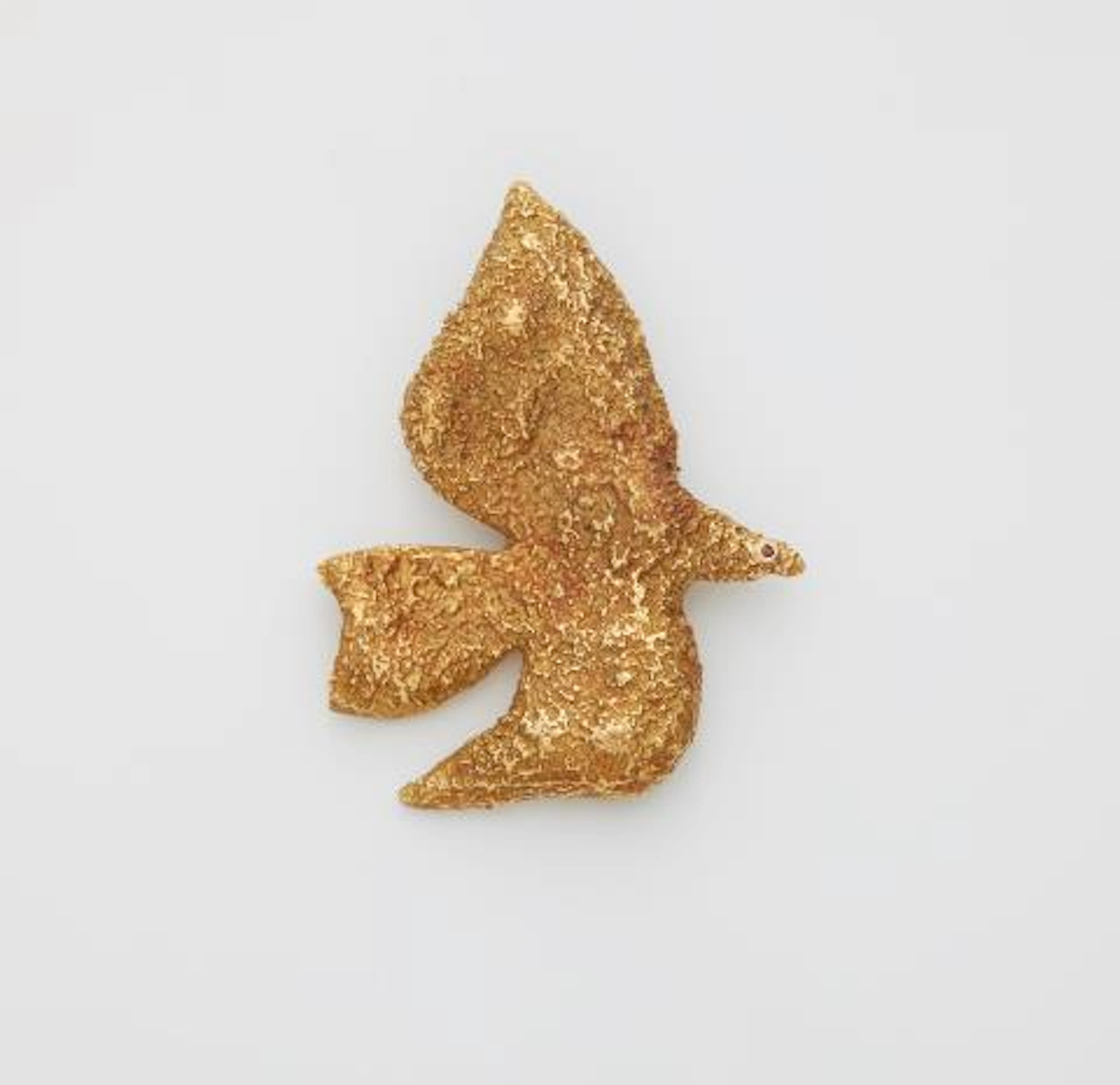 A textured 18k gold brooch "Thyria" with ruby collet eye.