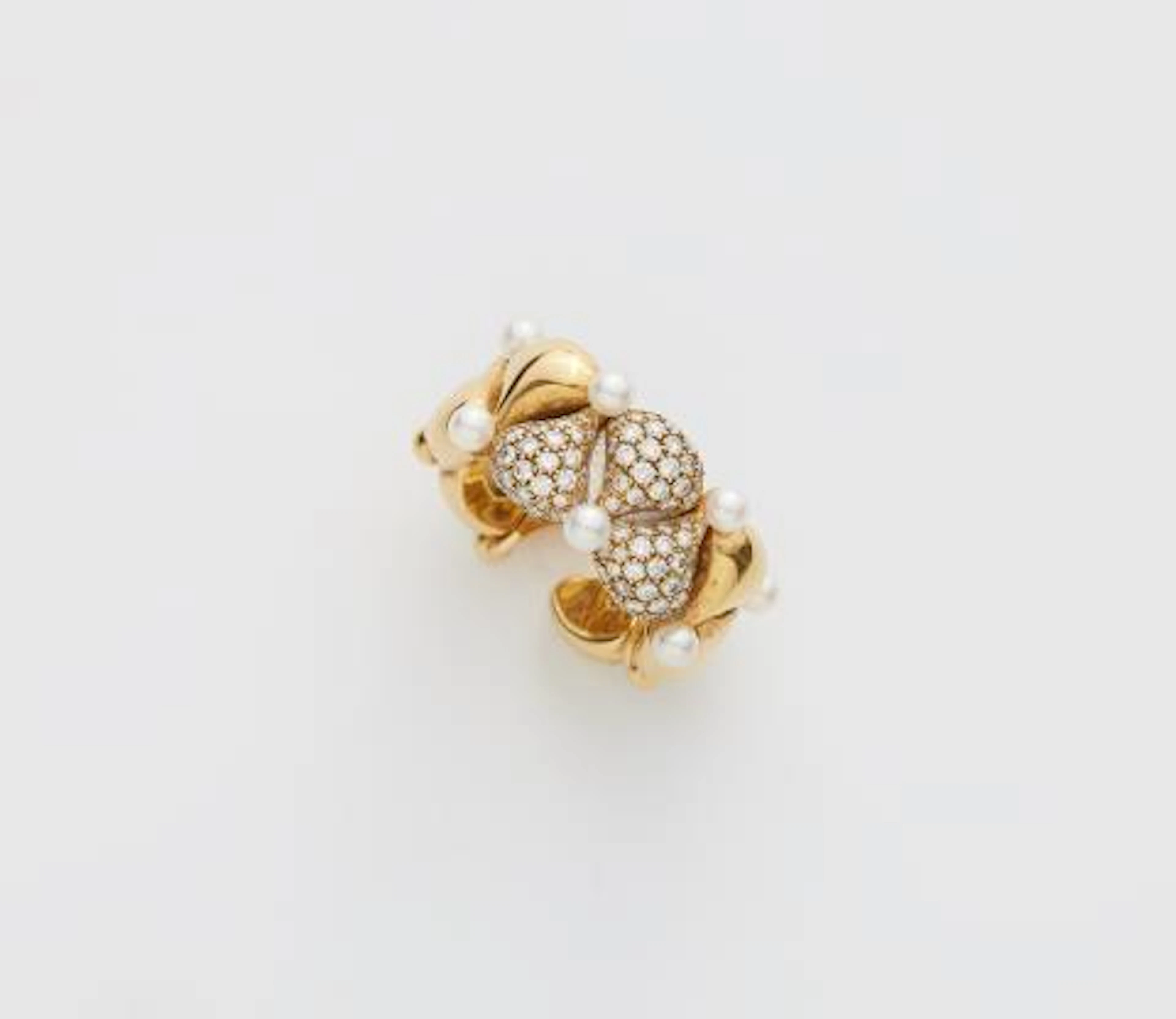 An 18k yellow gold diamond and pearl "Pushkin" flexible band ring.