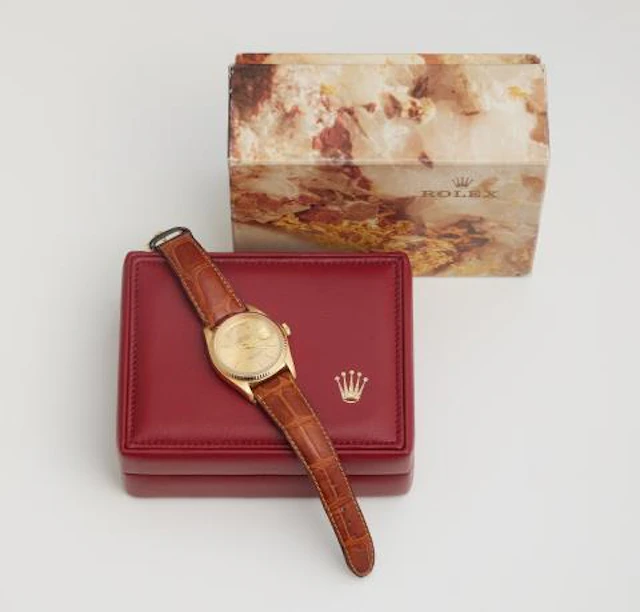 An 18k gold Rolex Day Date wristwatch.