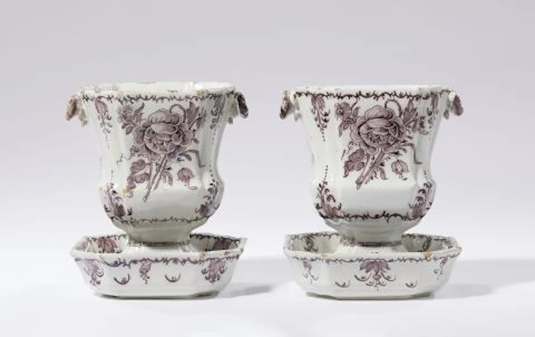A rare pair of Dutch Delft cachepots on stands
