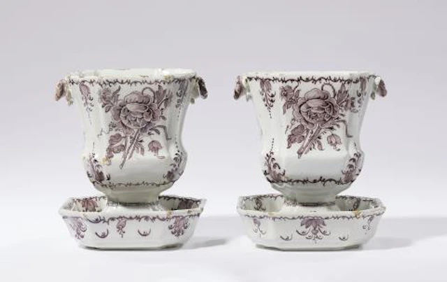 A rare pair of Dutch Delft cachepots on stands
