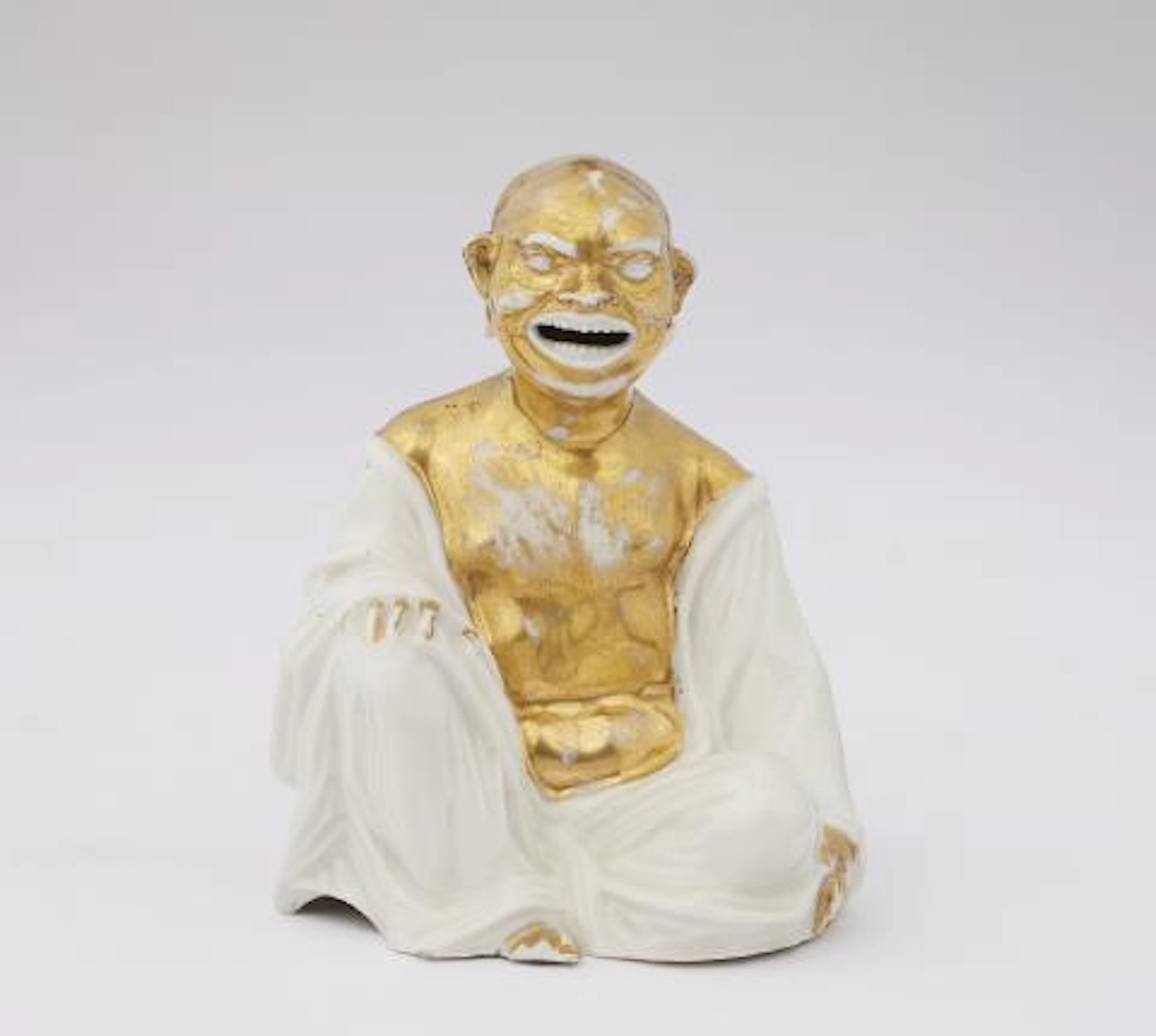 A Meissen porcelain figure of a seated Budai