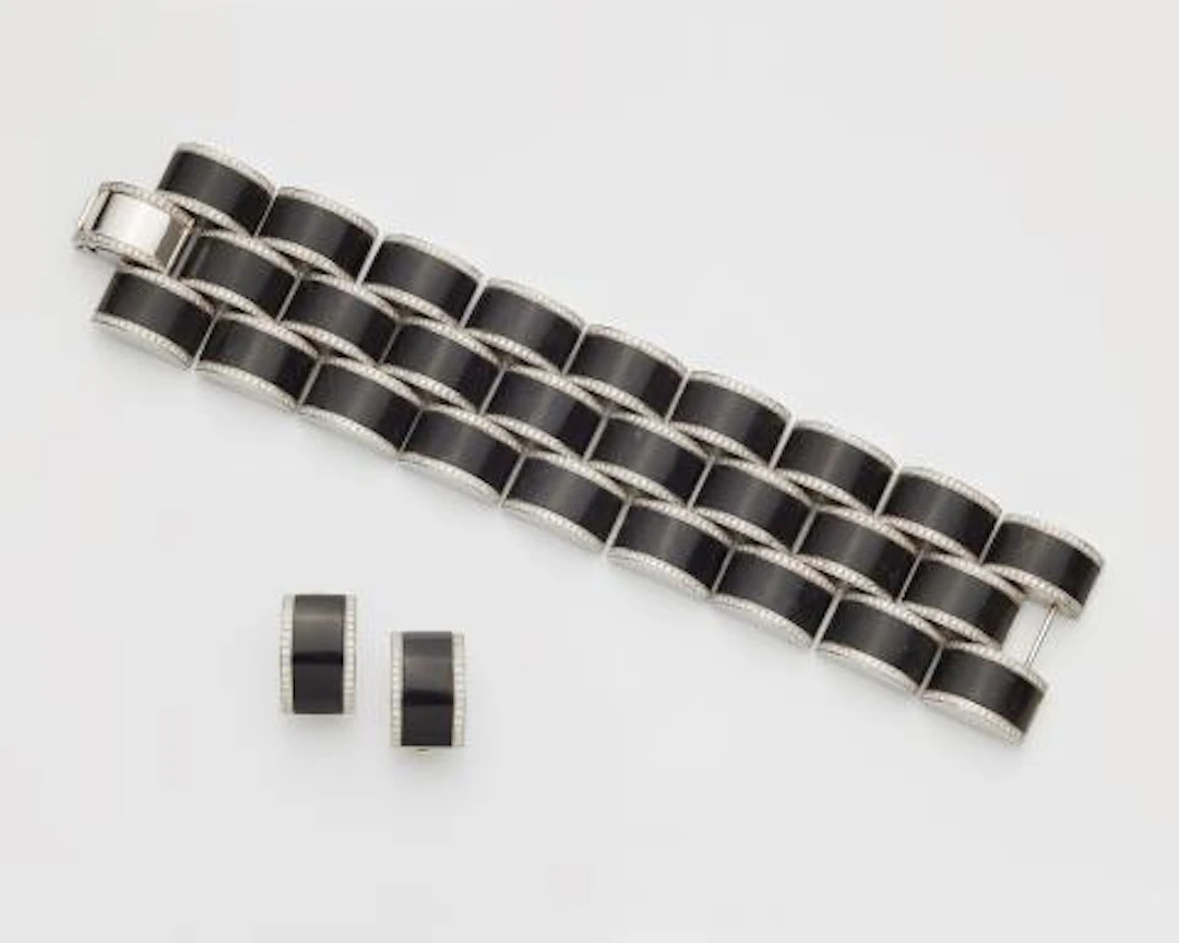 An 18k white gold ebony and diamond demi-parure.