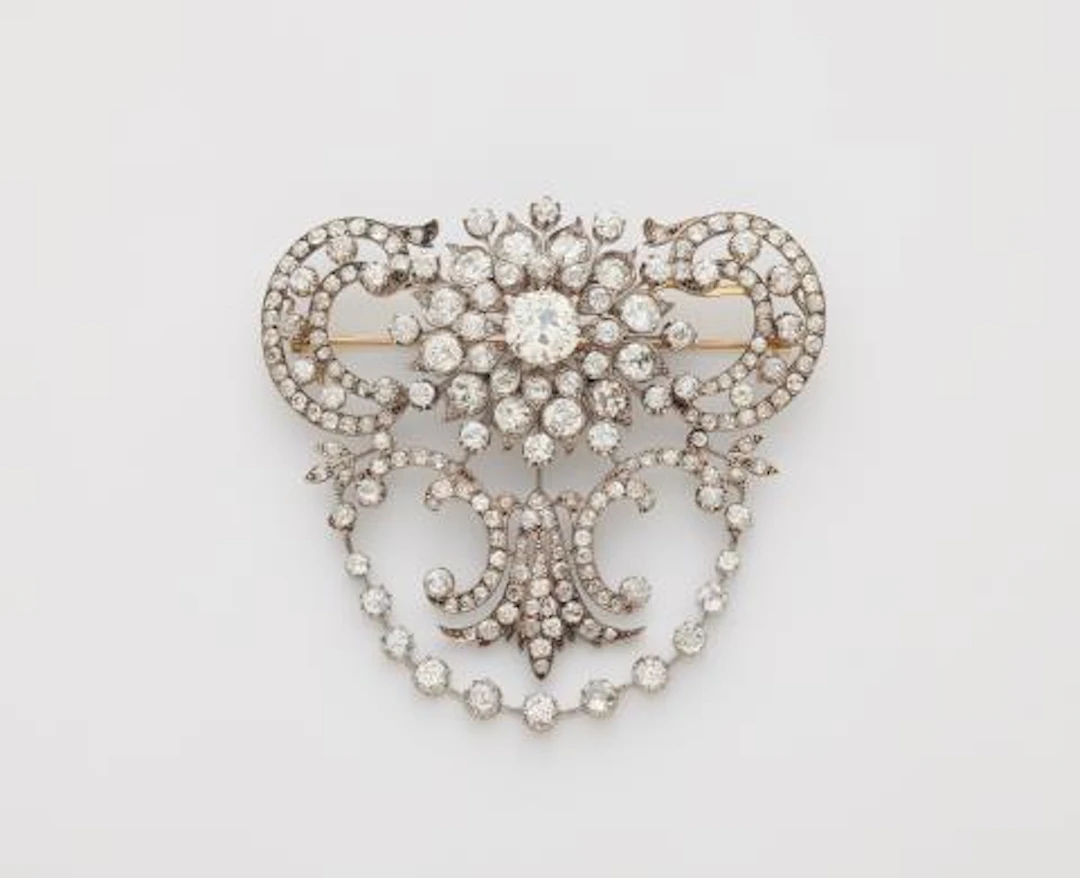 An important silver 14k gold and diamond Belle Epoque stomaker brooch.